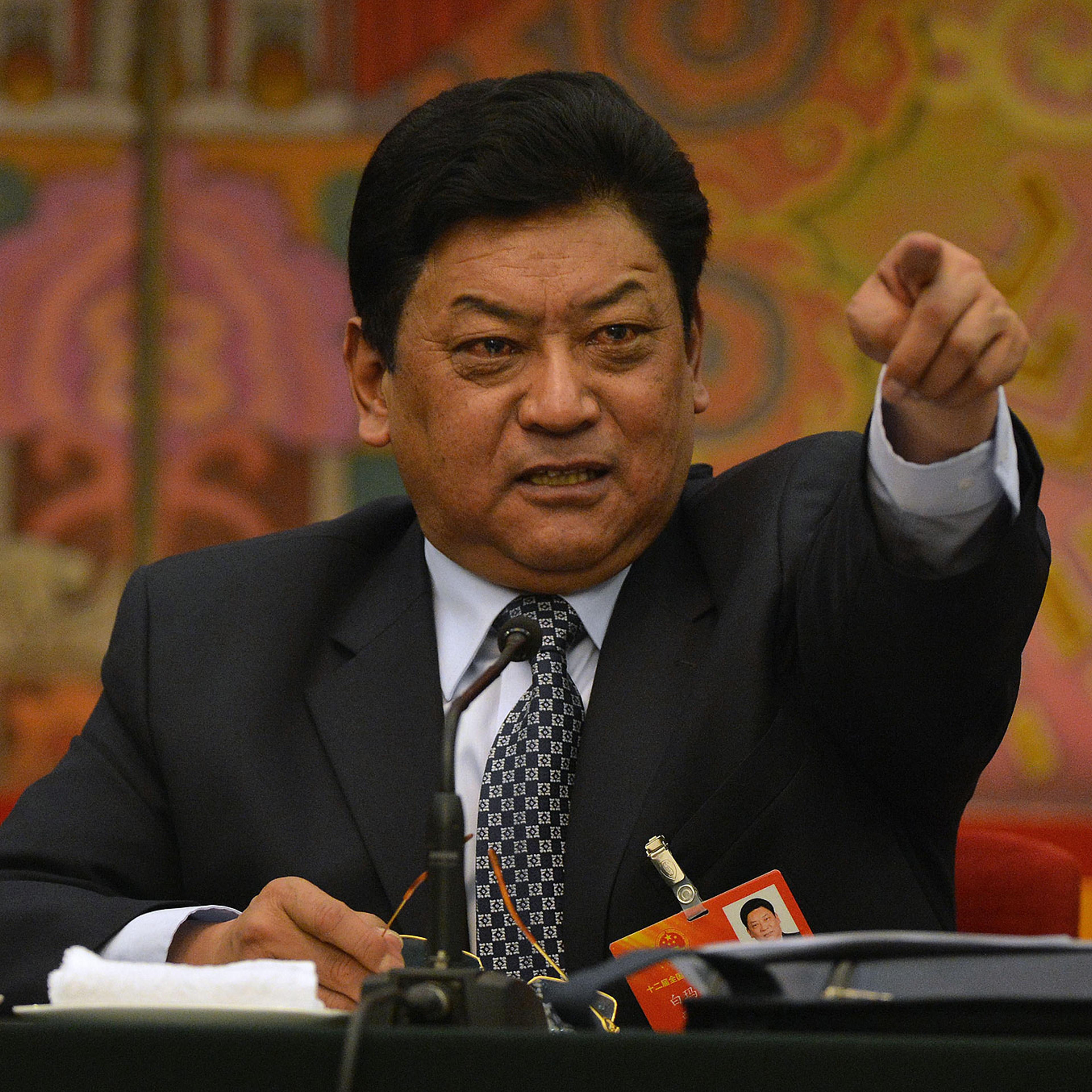 Padma Choling, head of China's Tibet Autonomous Region Congress gestures during their open session in the Great Hall of the people at the National People's Congress in Beijing on March 8, 2013