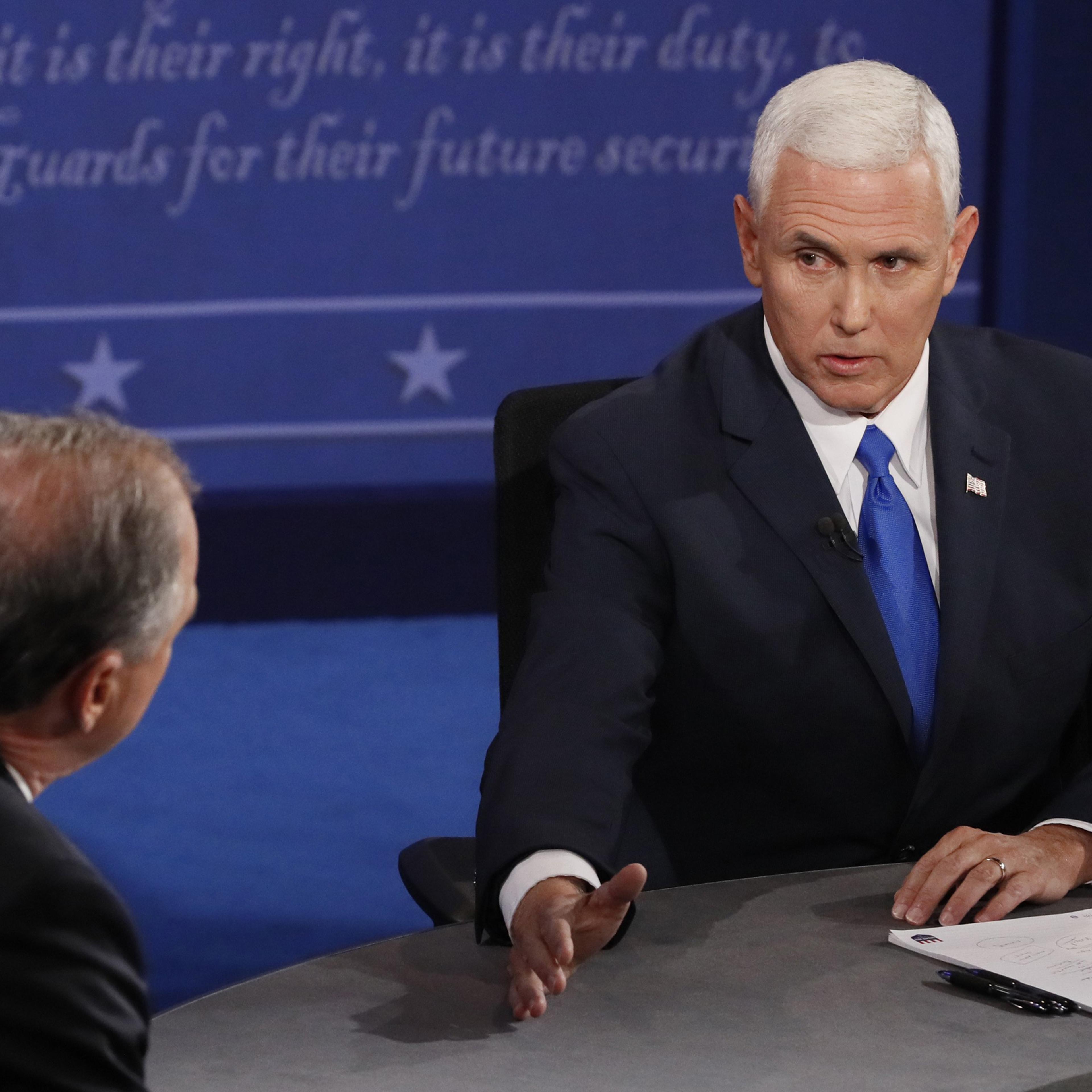 Democratic candidate for Vice President Tim Kaine (L) exchanges with Republican candidate for Vice President Mike Pence (R) during the first vice presidential debate at Longwood University in Farmville, Virginia, on Oct. 4, 2016.