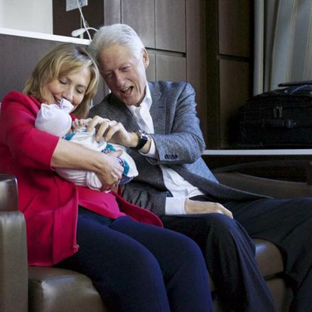 Hillary and Bill Clinton with their granddaugther Charlotte