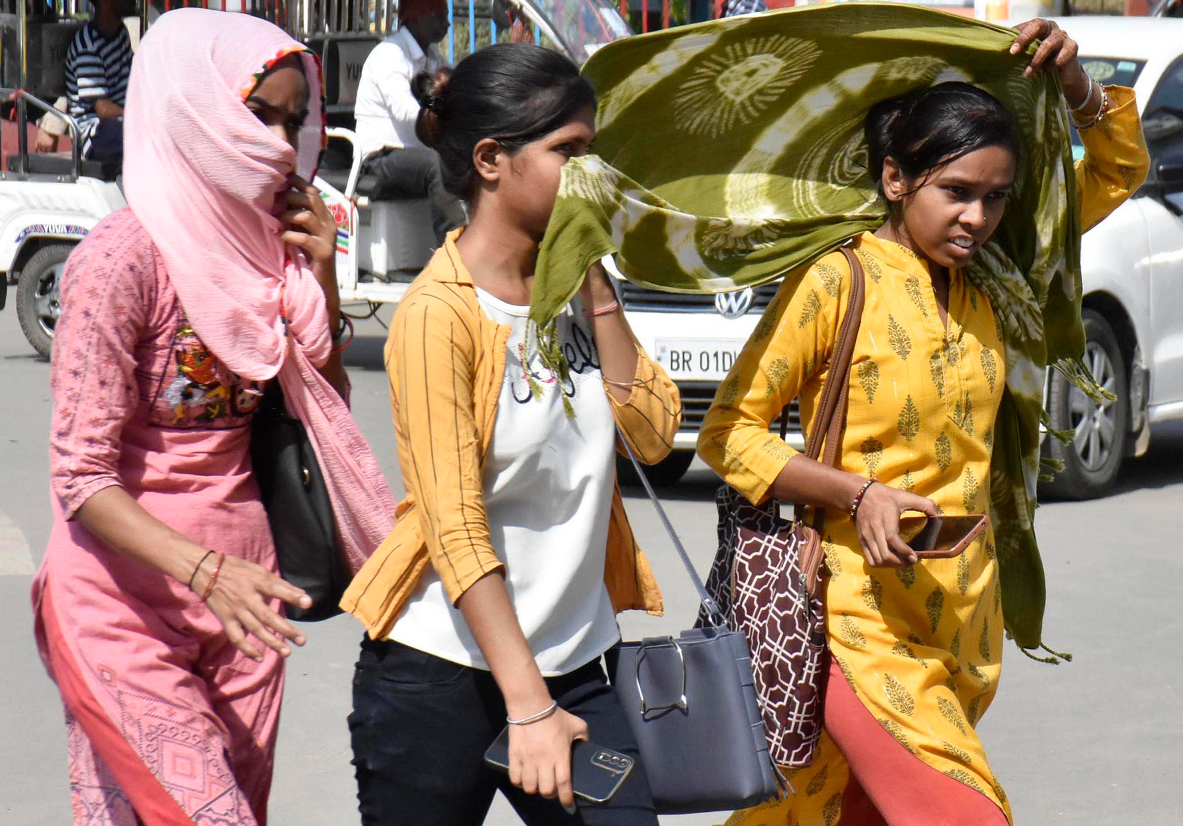 Women covering their face with dupatta during a hot summer day at Kargil Chowk, in Patna, India, on June 4. 