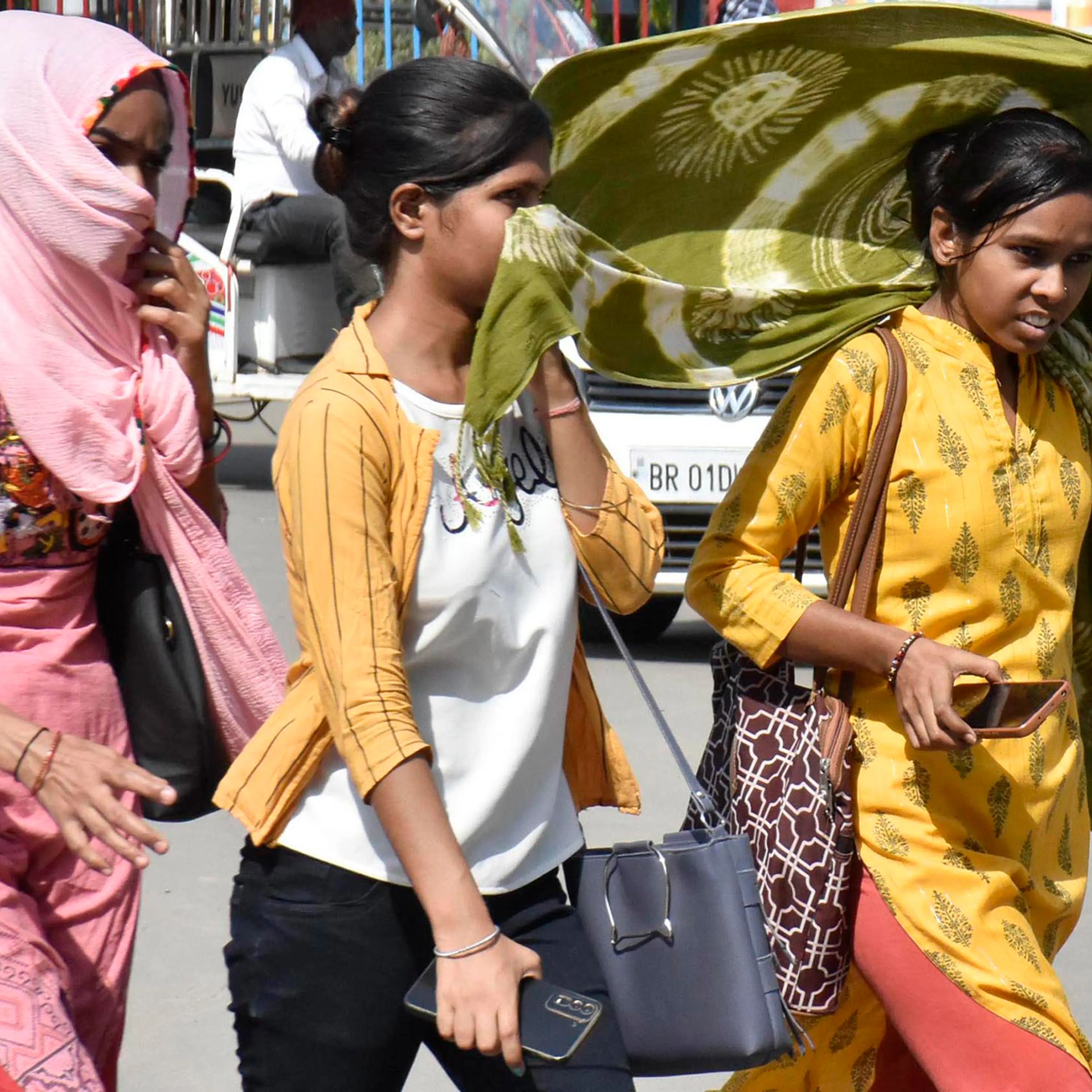 Women covering their face with dupatta during a hot summer day at Kargil Chowk, in Patna, India, on June 4.