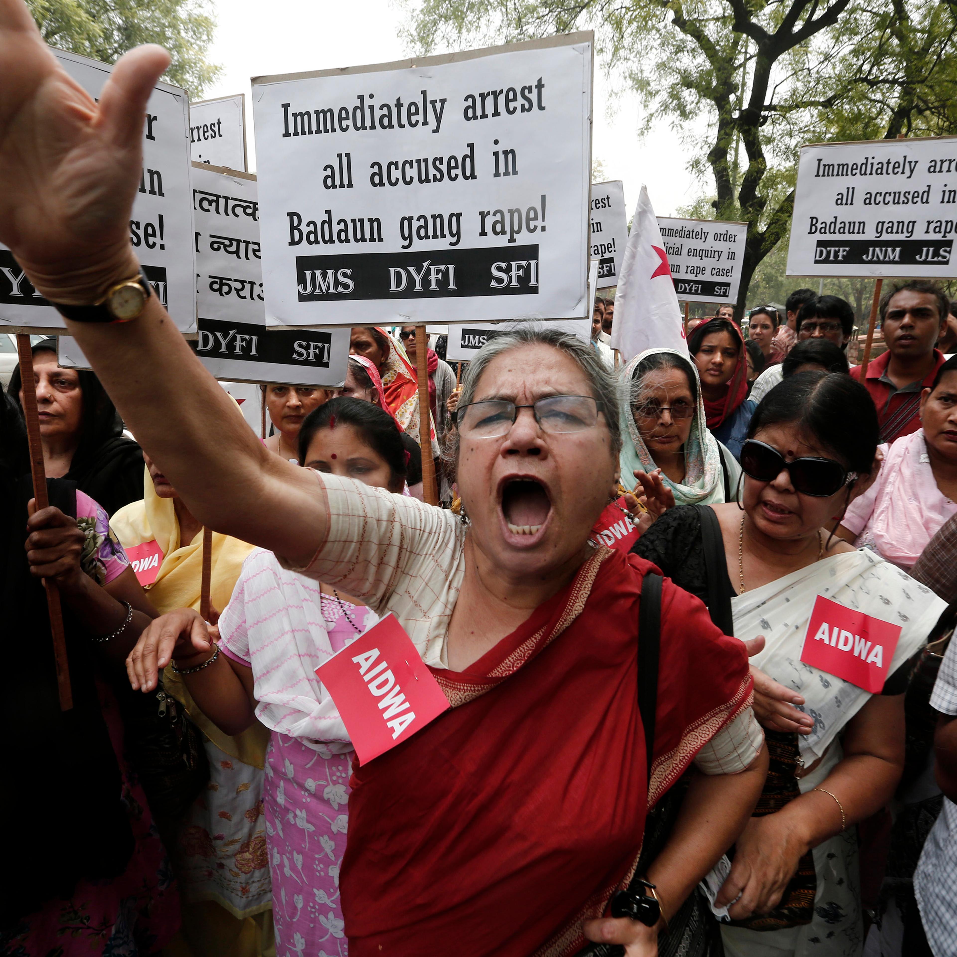 Demonstrators from AIDWA hold placards and shout slogans during protest against recent killings of two teenage girls, in New Delhi
