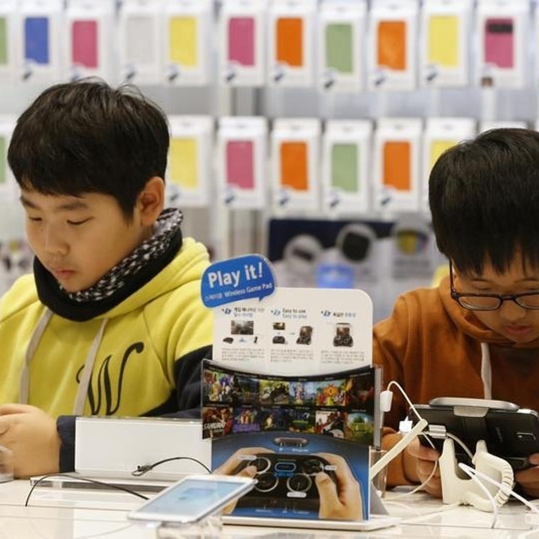 People try out Samsung Galaxy phones at the Samsung Electronics' headquarters in Seoul