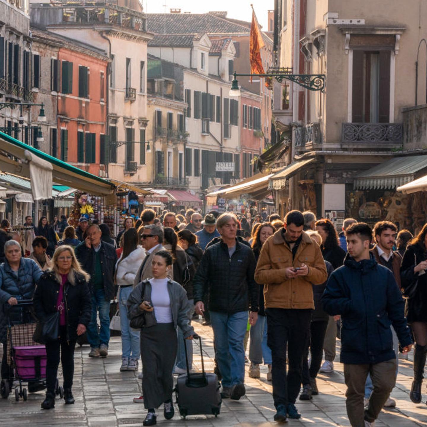Tourists line a street in Venice, Italy, on Saturday, March 16, 2024.