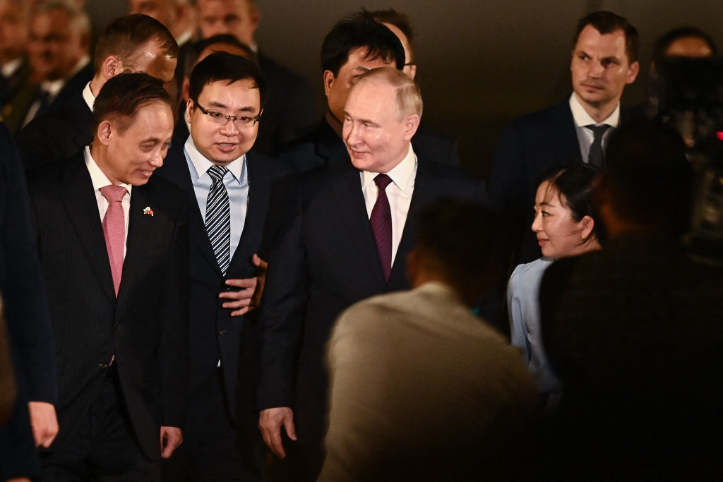 Russia's President Vladimir Putin walks to a car upon his arrival in Vietnam, at the Noi Bai International Airport in Hanoi on June 20, 2024.