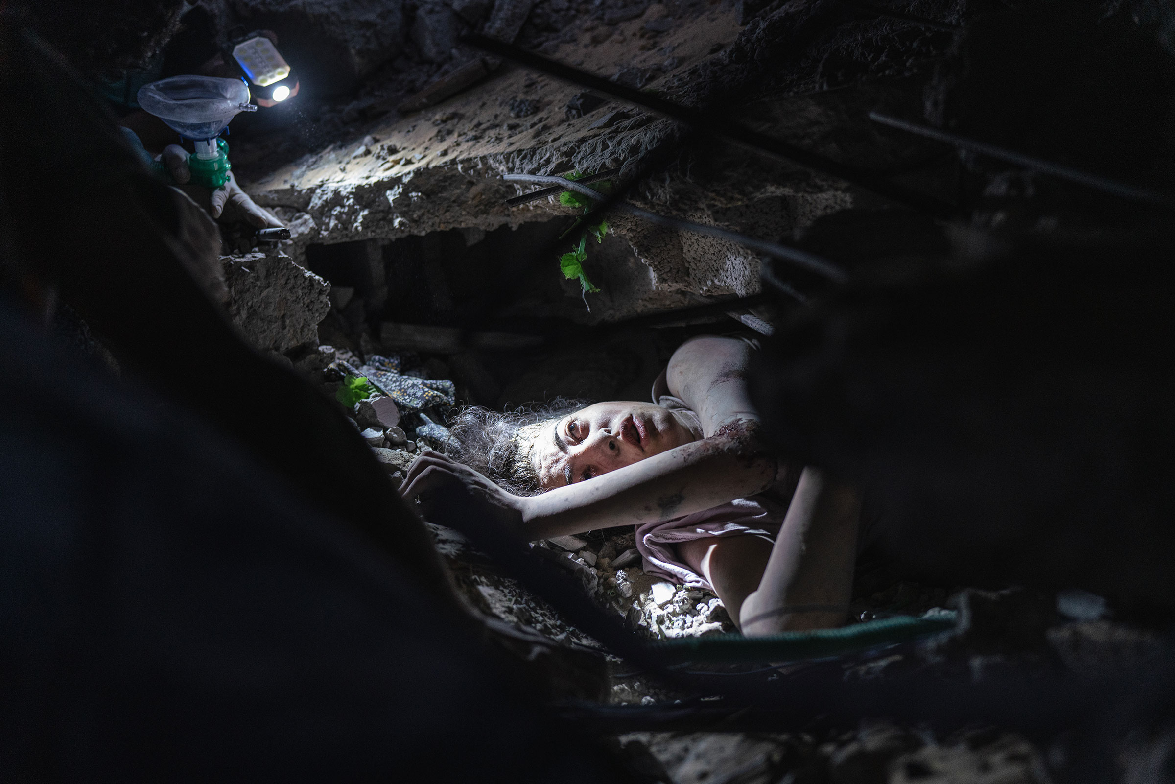A young girl stuck under her house rubble after it was bombed by Israeli airstrikes, Al Nusairat refugee camp, Oct. 31.