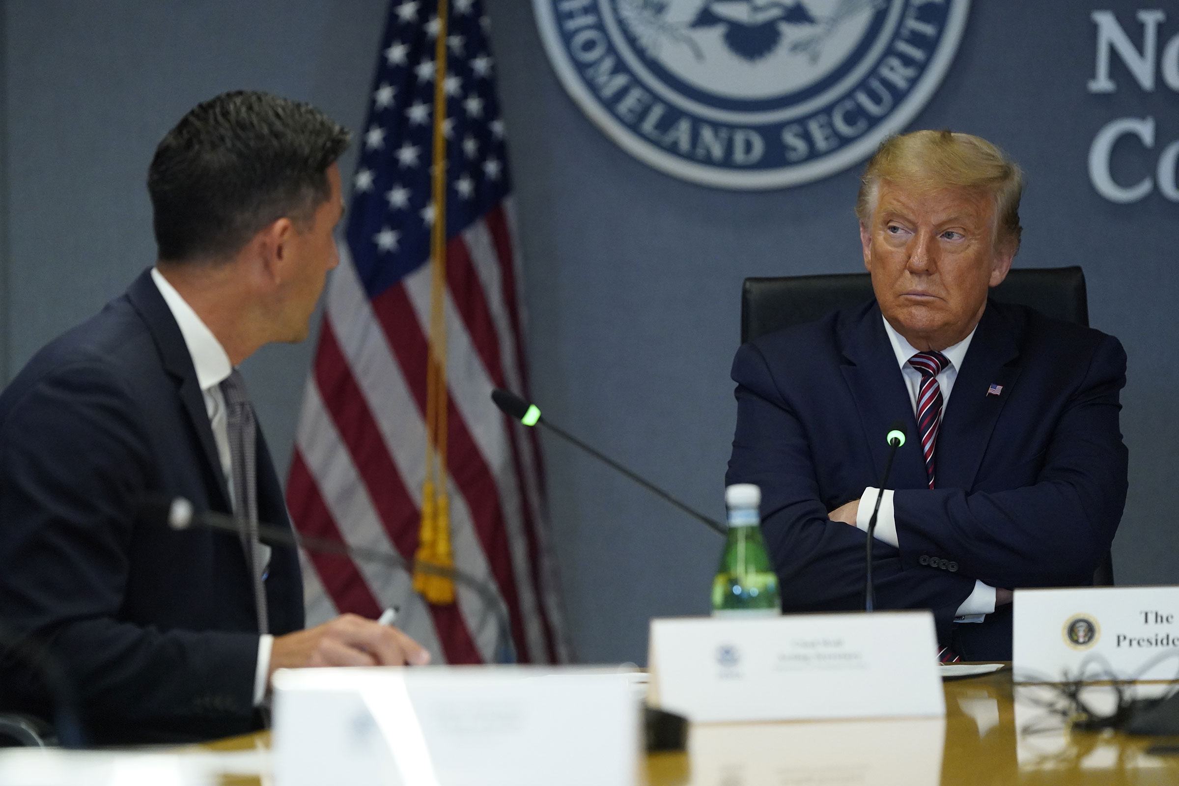 President Donald Trump listens while Chad Wolf, acting secretary of the Department of Homeland Security speaks during a meeting at FEMA headquarters in Washington on Aug. 27, 2020.