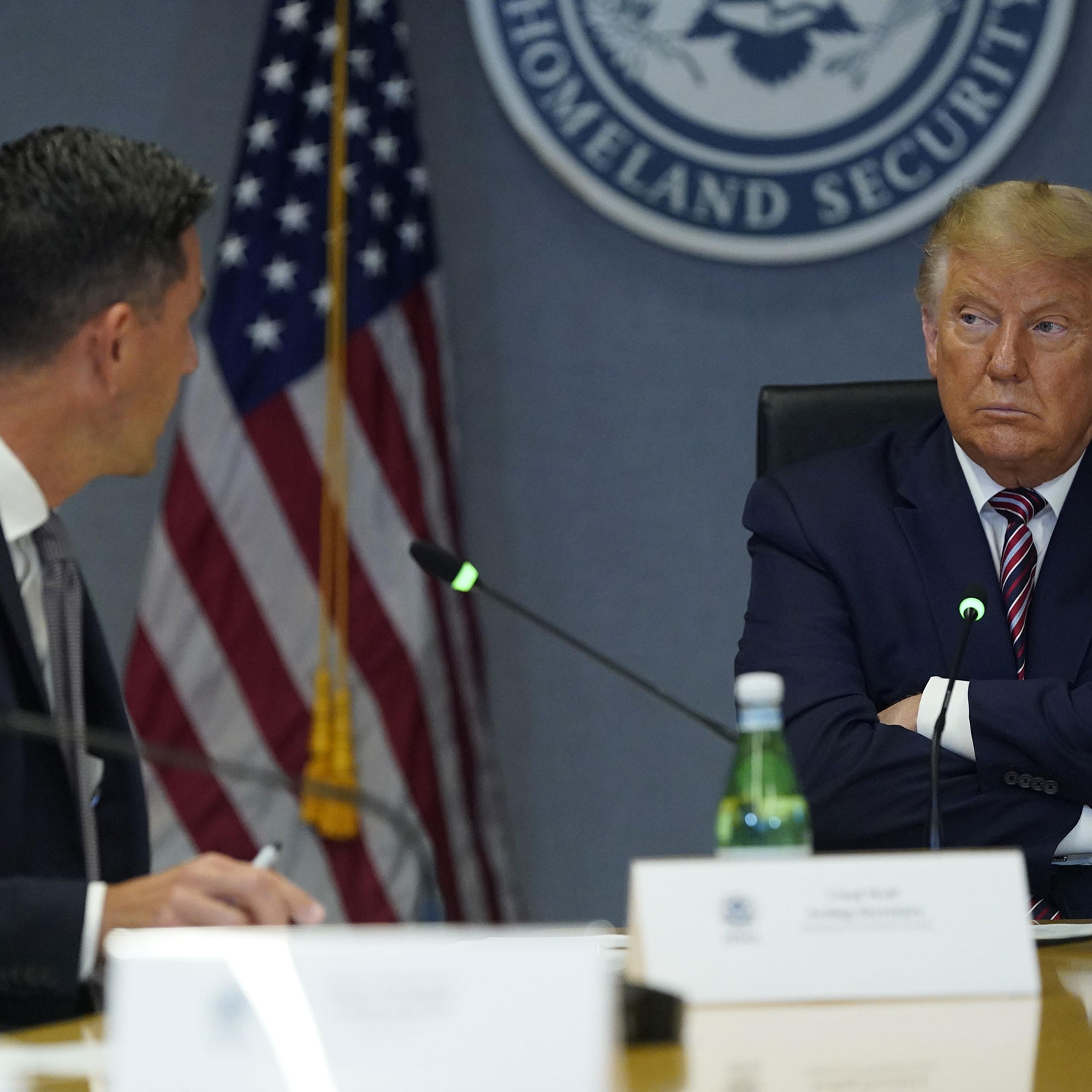 President Donald Trump listens while Chad Wolf, acting secretary of the Department of Homeland Security speaks during a meeting at FEMA headquarters in Washington on Aug. 27, 2020.