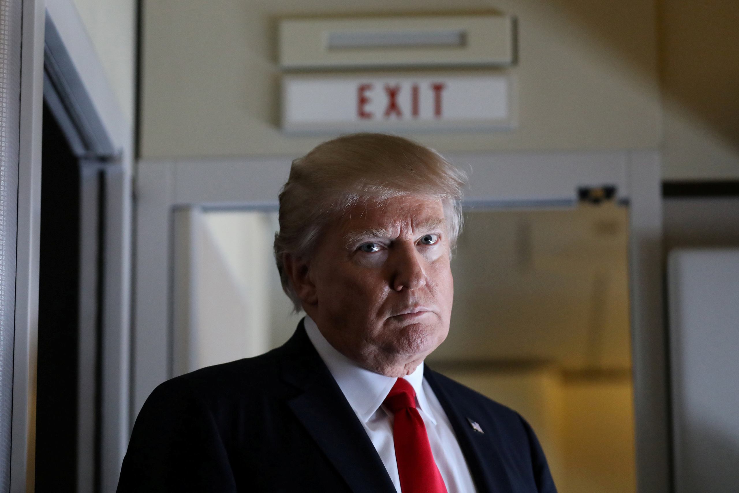 President Trump pauses as he talks to journalists who are members of the White House travel pool on board Air Force One during flight to Palm Beach, Florida