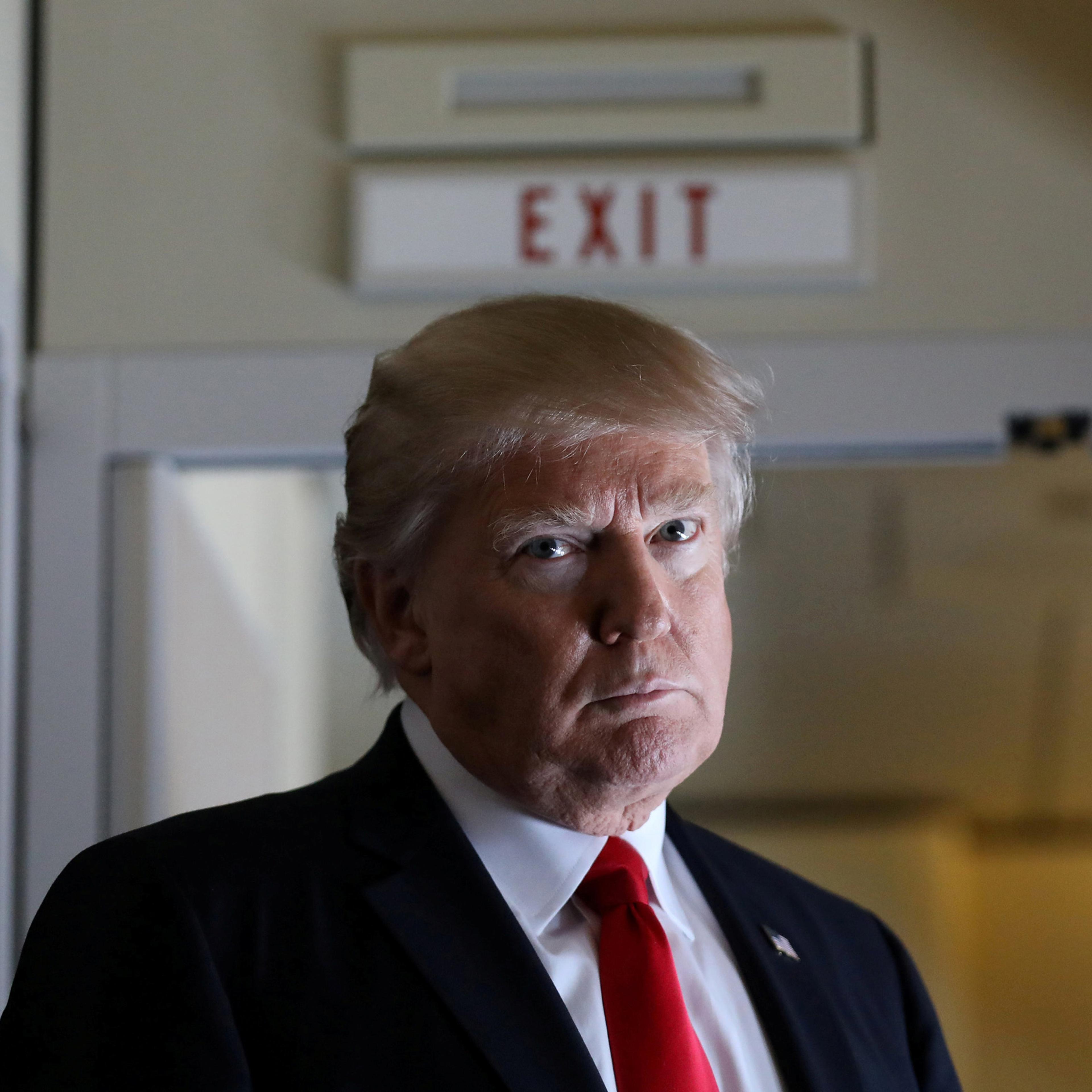 President Trump pauses as he talks to journalists who are members of the White House travel pool on board Air Force One during flight to Palm Beach, Florida