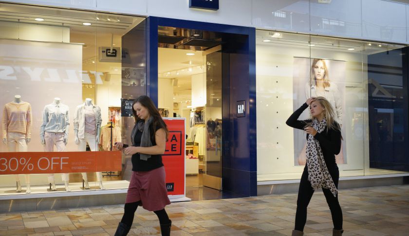 Passers-by walk next to a Gap store in Broomfield, Colorado