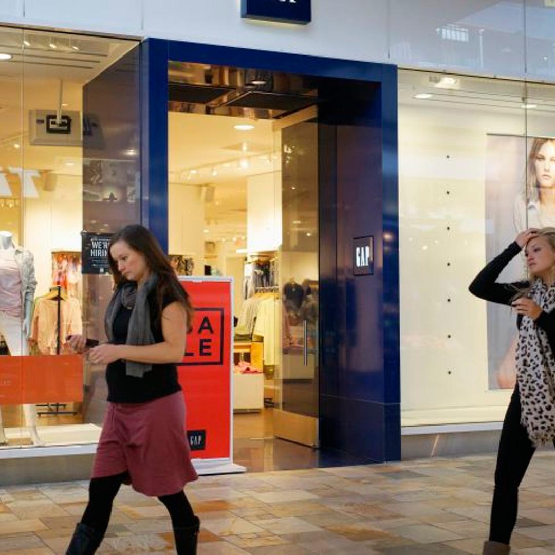 Passers-by walk next to a Gap store in Broomfield, Colorado