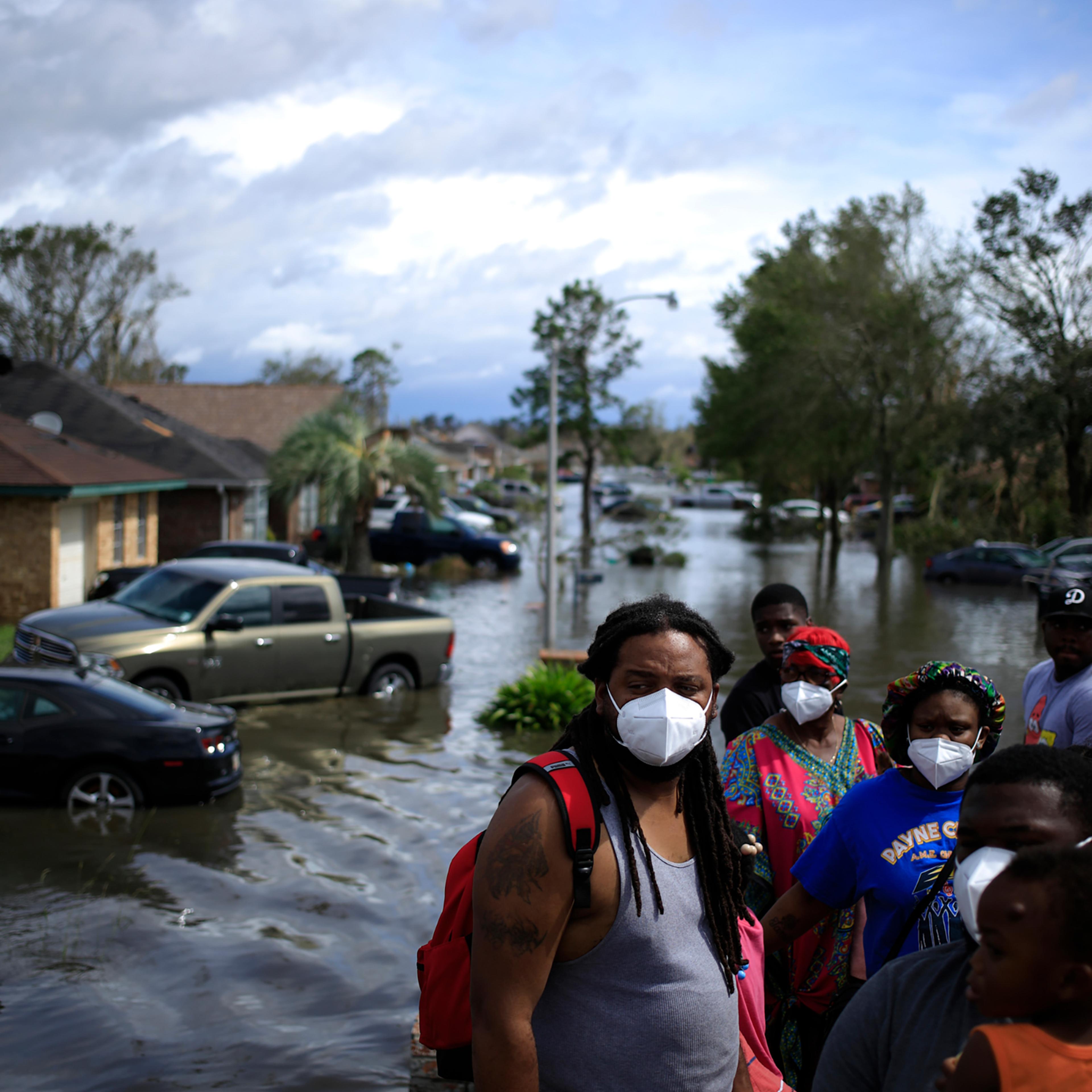 Residents ride in a high water vehicle after being rescued from floodwater left behind by Hurricane Ida in LaPlace, La. on Aug. 30.