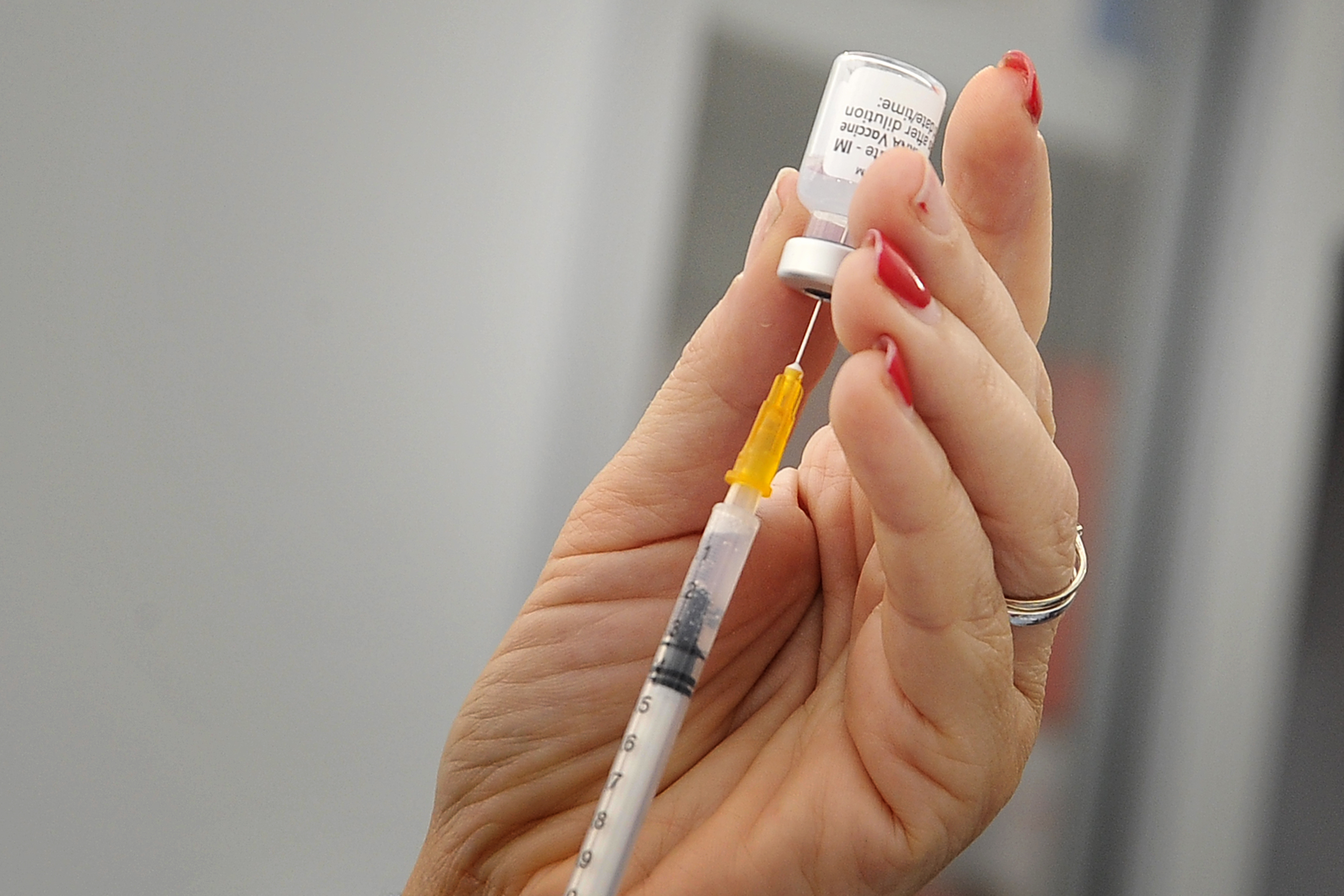 Nurse while preparing a dose of Pfizer vaccine, inside the