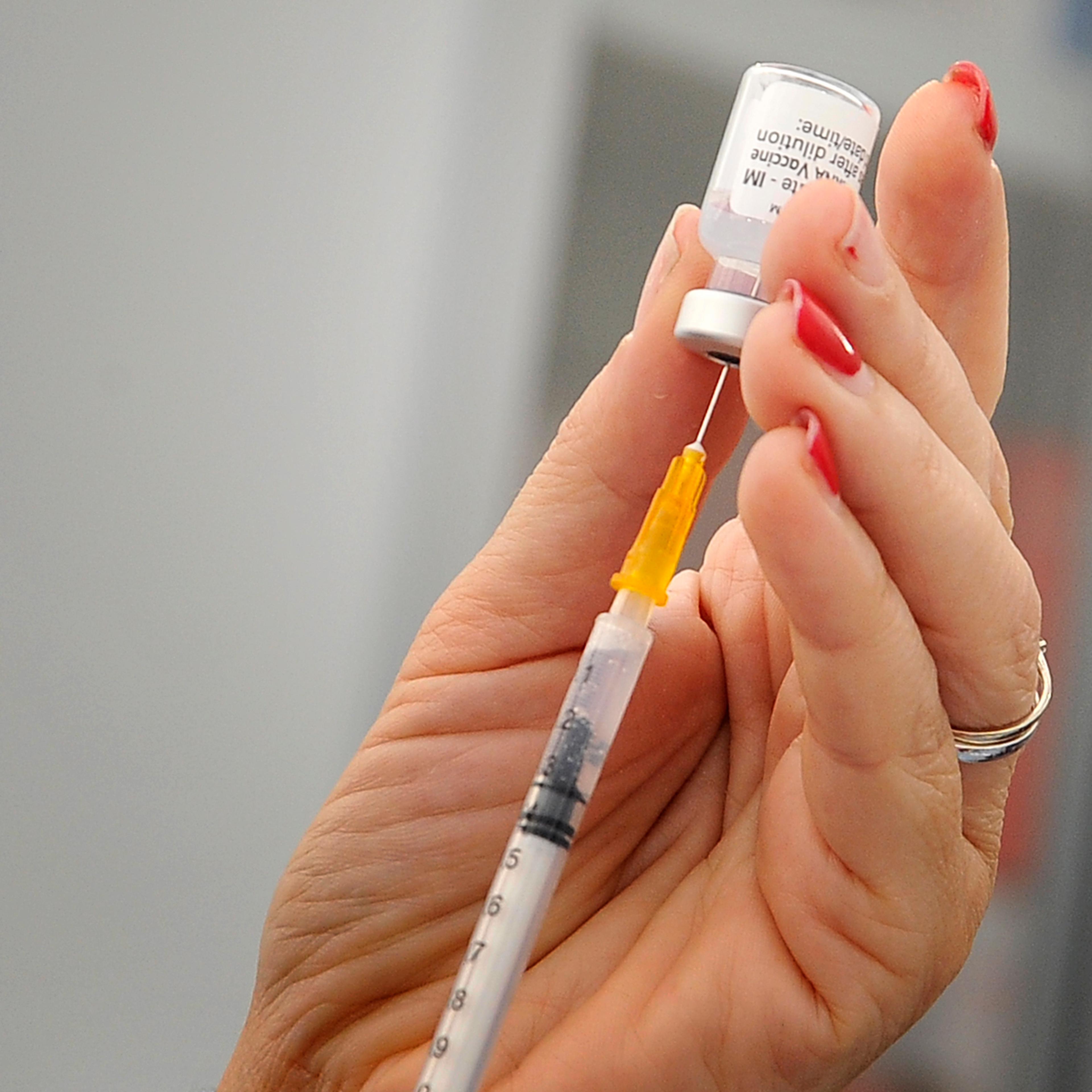 Nurse while preparing a dose of Pfizer vaccine, inside the