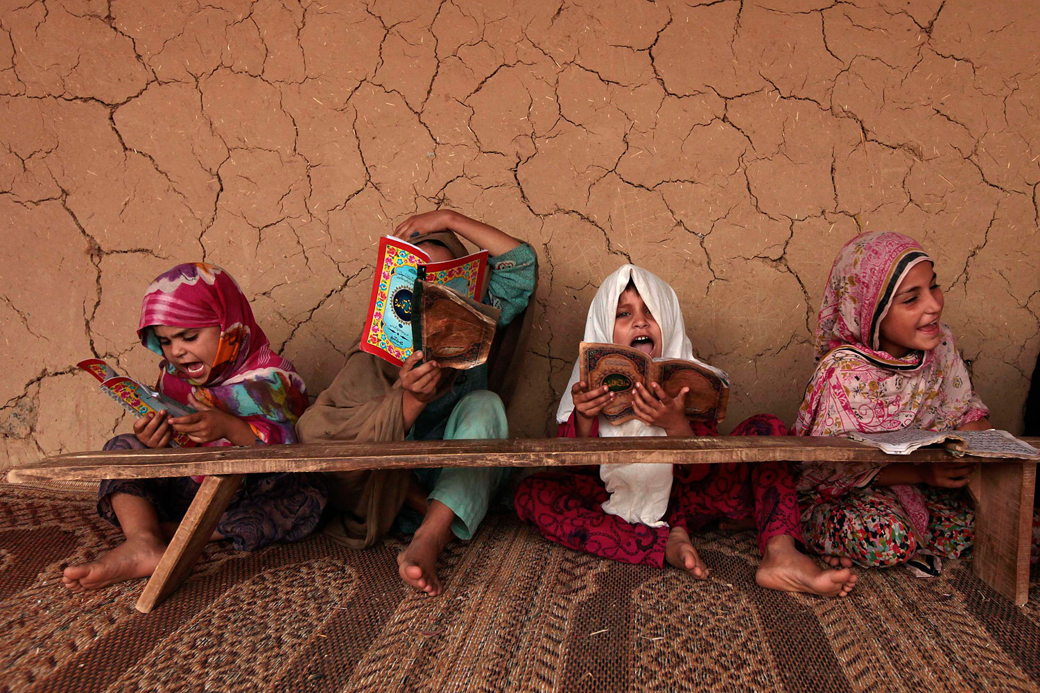 Girls read books containing short verses from the Koran in a madrasa, or religious school, on the outskirts of Islamabad.
