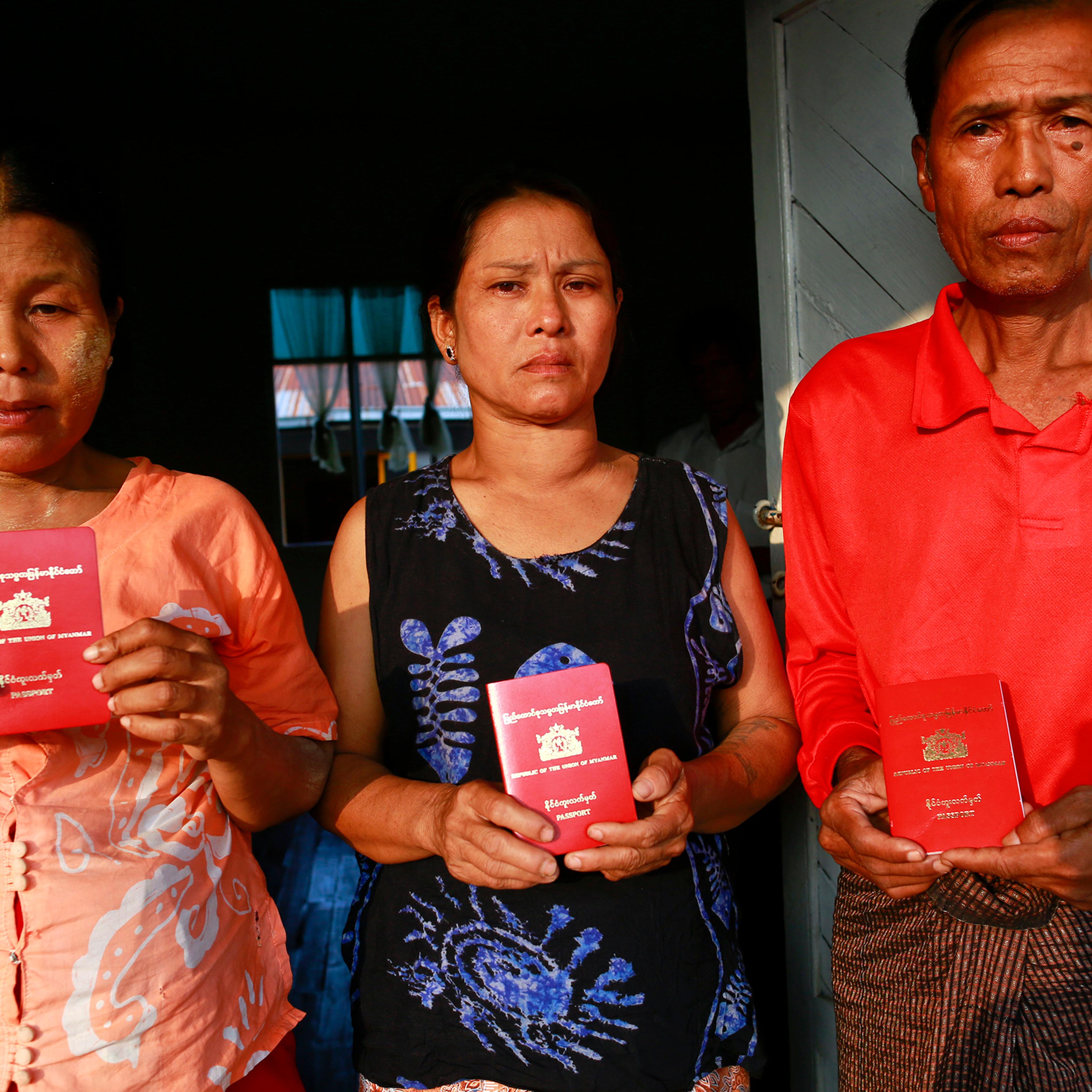Parents of Myanmar workers suspected of killing British tourist in Thailand, show their passports as at a monastery outside Yangon