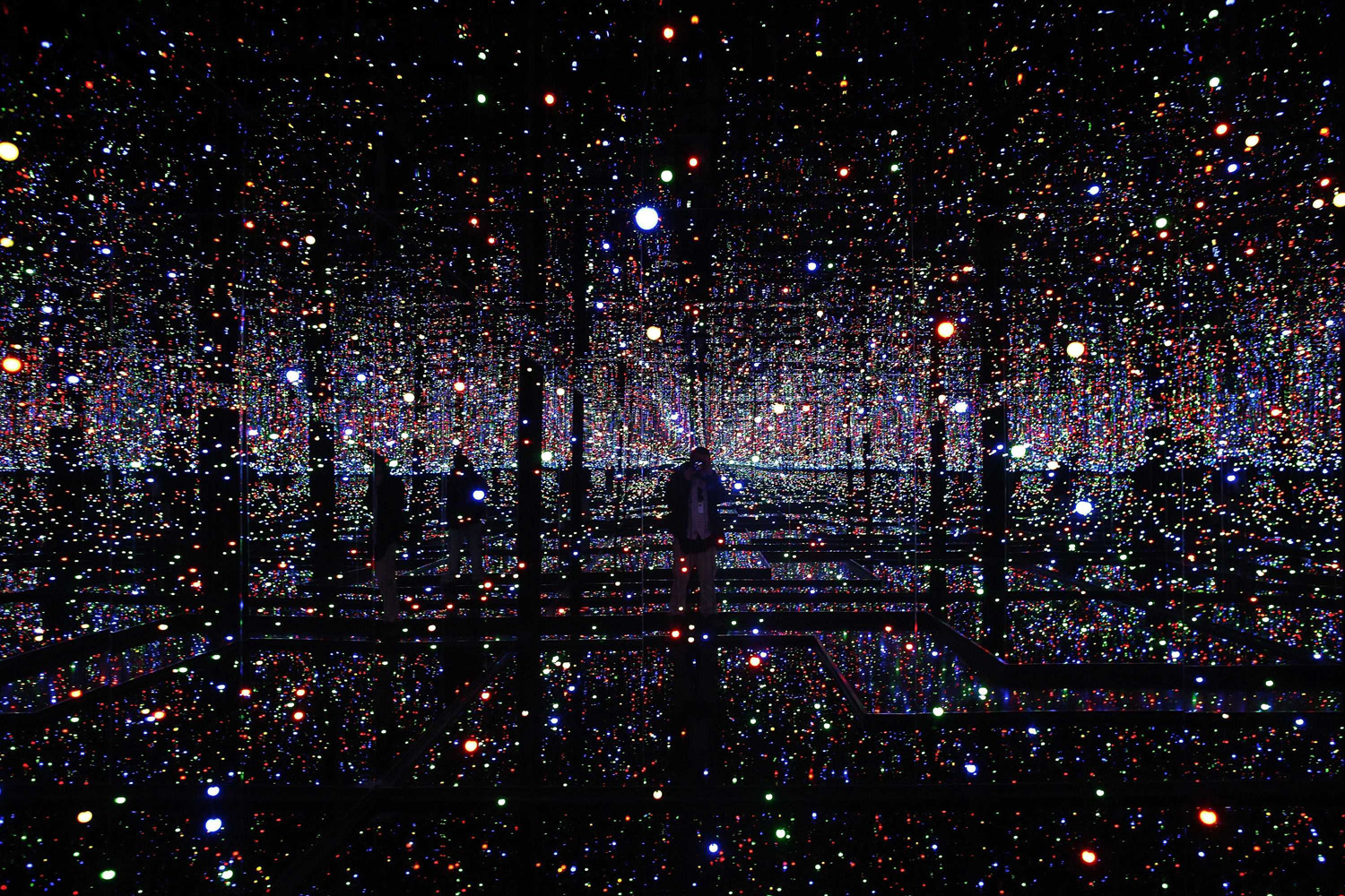 Photographer takes pictures of an installation titled "Infinity Mirrored Room - Filled With the Brilliance of Life" by Japanese artist Yayoi Kusama during her exhibition at the Rufino Tamayo museum in Mexico City
