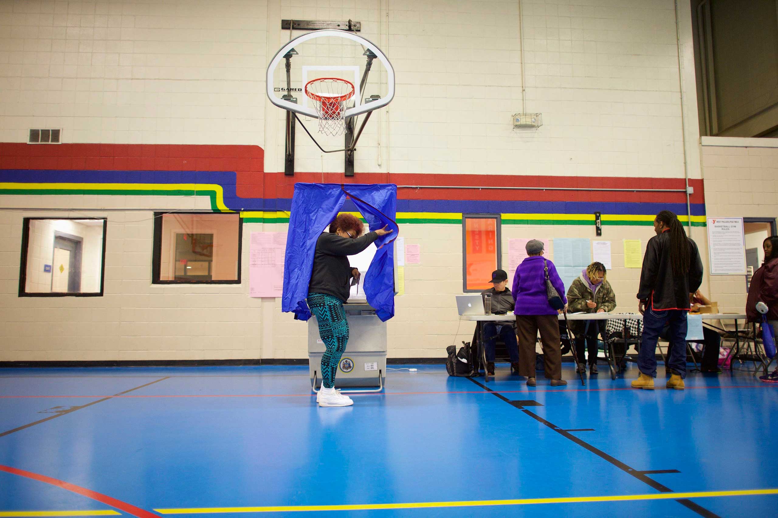 Deborah Brown, 60, emerges from the voting booth after casting her ballot on U.S. midterm election day morning at the West Philadelphia YMCA in Philadelphia