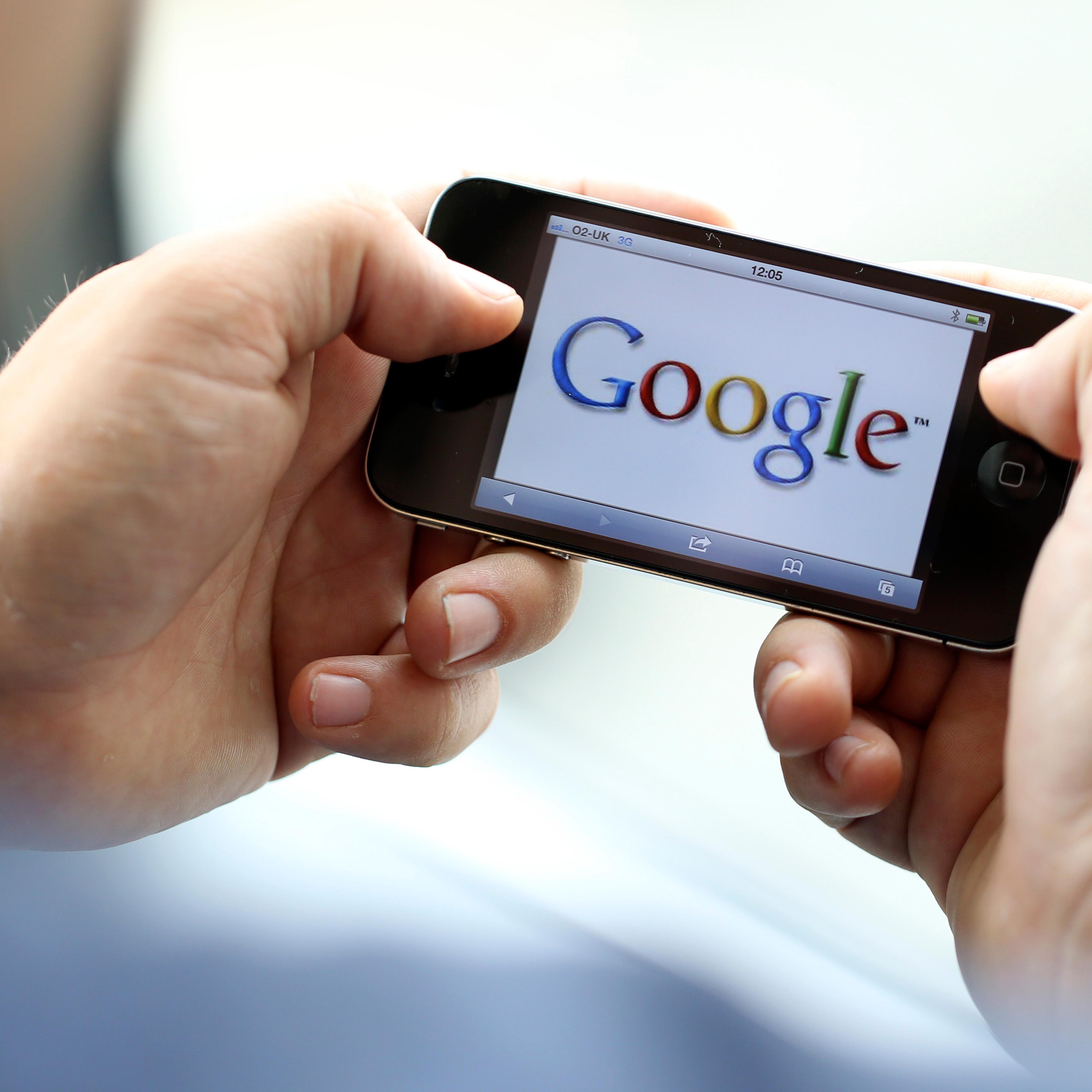 The Google Inc. company logo is seen on an Apple Inc. iPhone 4 smartphone in this arranged photograph in London, U.K., on Wednesday, Aug. 29, 2012.