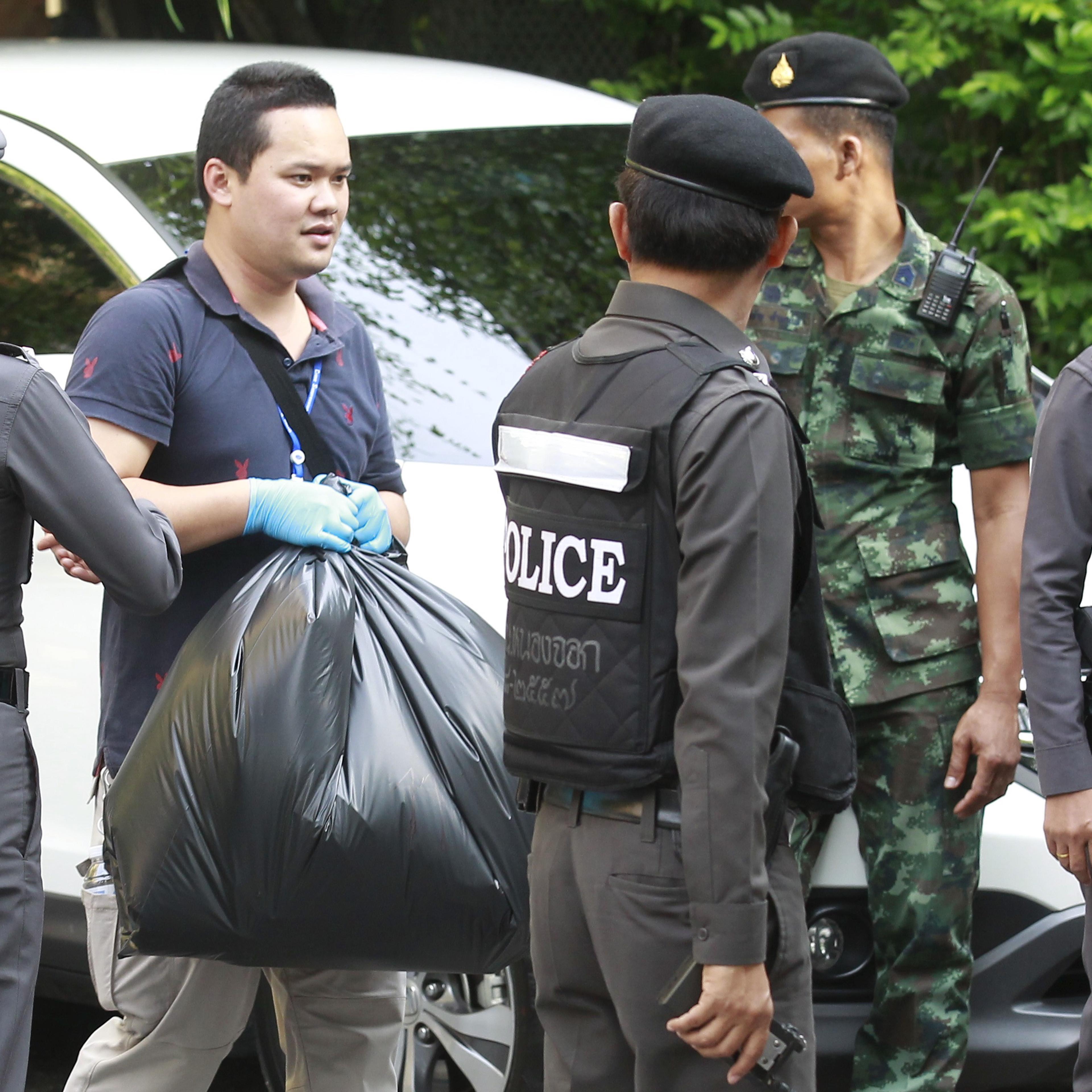 Thai Royal Police officials remove evidence from the site where a suspect of the recent Bangkok blast was arrested, in Bangkok