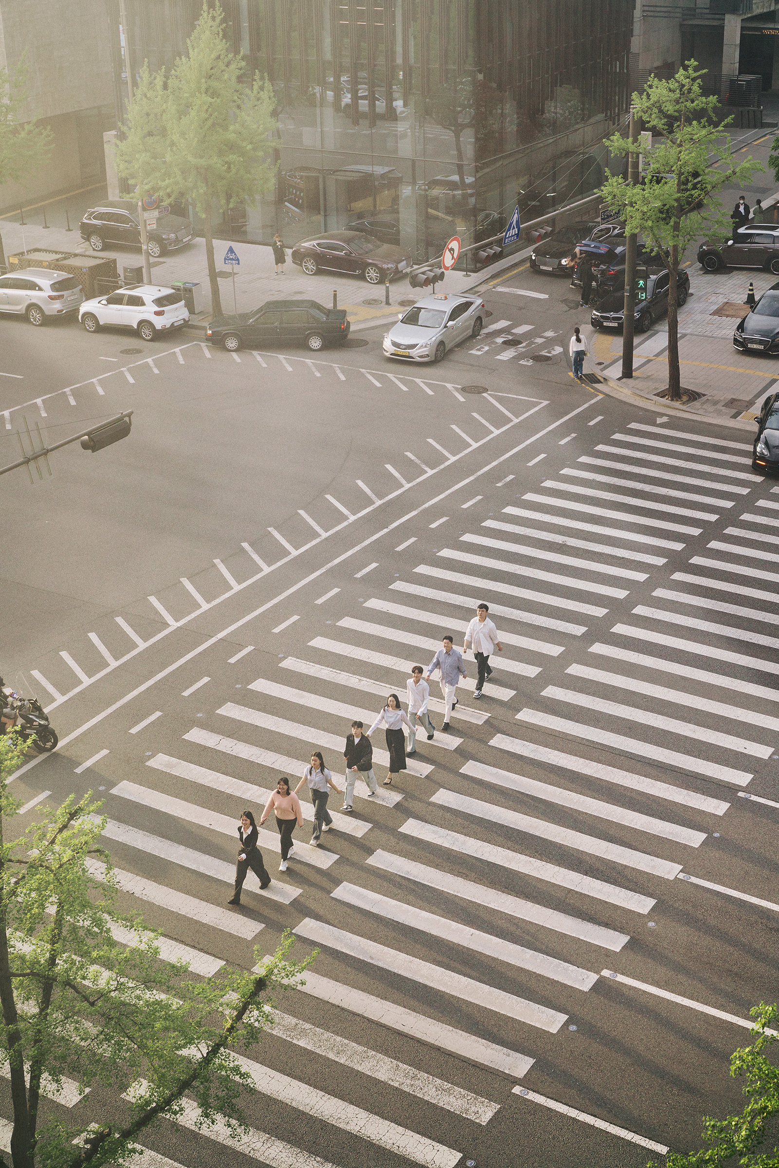 From left, Moon Dana, Yeon Gahyeon, Jeongbin Park, Aiden Won Kim, Chang Eun-ha, Derrick Park, Choi Yunu, and Lee Jaehyun—student peer specialists as well as the president of Mental Health Korea—cross a road in Gangnam, Seoul, in April.