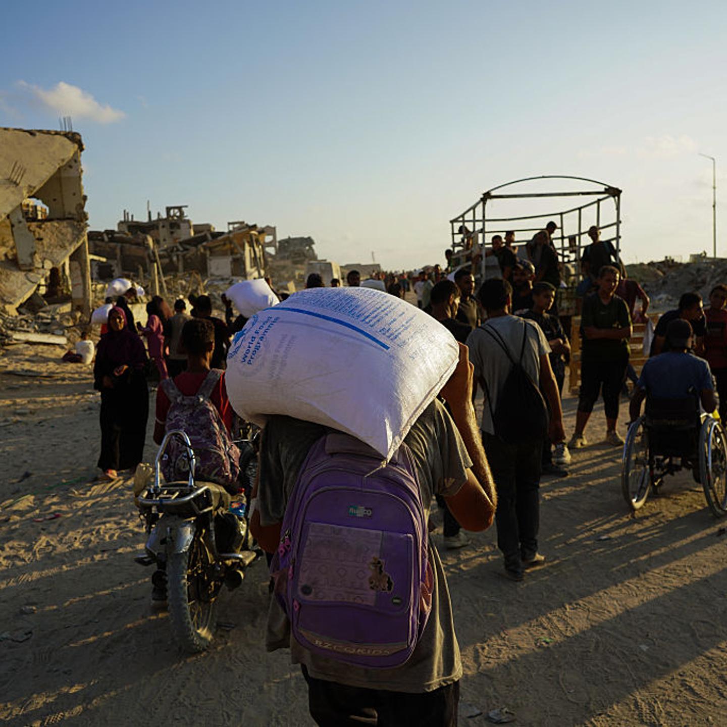 Palestinians receive limited amount of flour at distribution point in Gaza