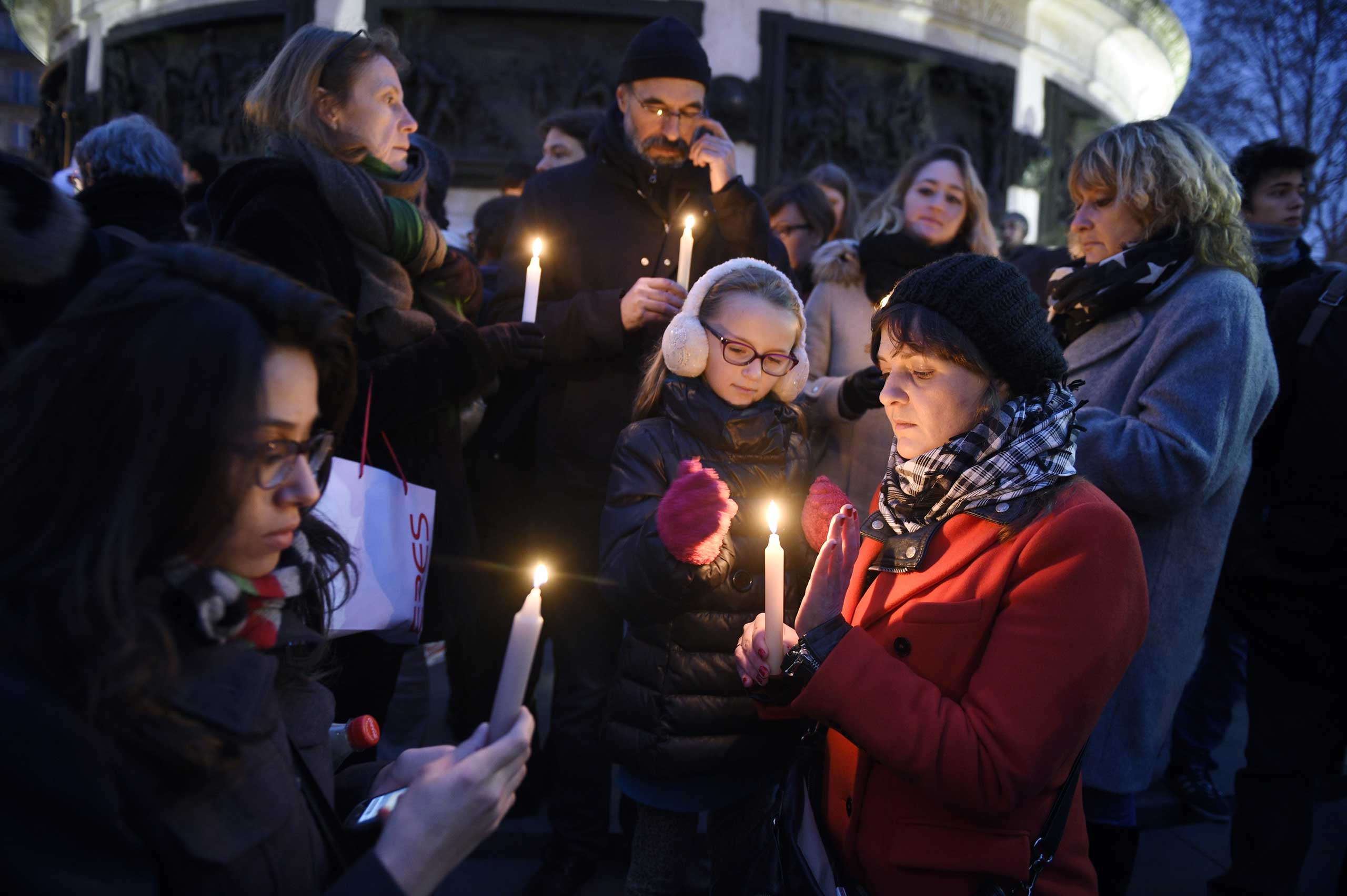 People like candles during a rally in support of the victims of the attack by gunmen at French satyrical newspaper Charlie Hebdo at the Place de la Republique in Paris, on Jan. 7, 2015.