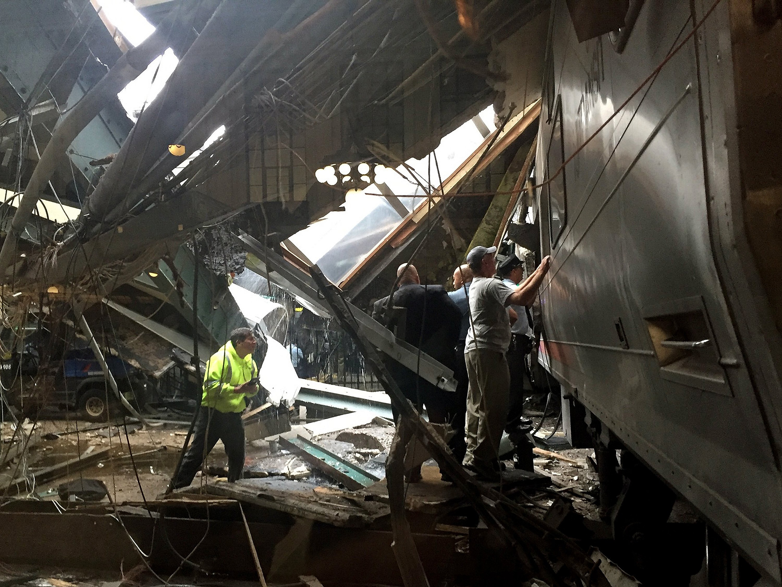 Train personel survey the NJ Transit train that crashed in to the platform at the Hoboken Terminal in Hoboken, New Jersey, Sept. 29, 2016.