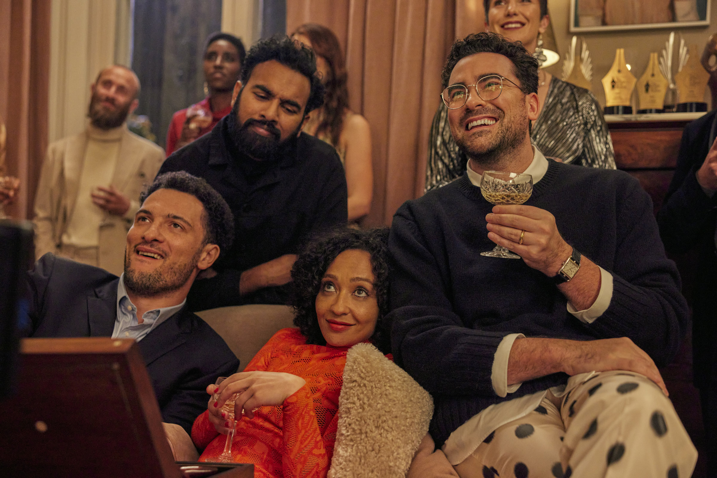 Terrance (Jamael Westman), Thomas (Himesh Patel), Sophie (Ruth Negga), and Marc (Daniel Levy) pile onto the couch at a Christmas party.