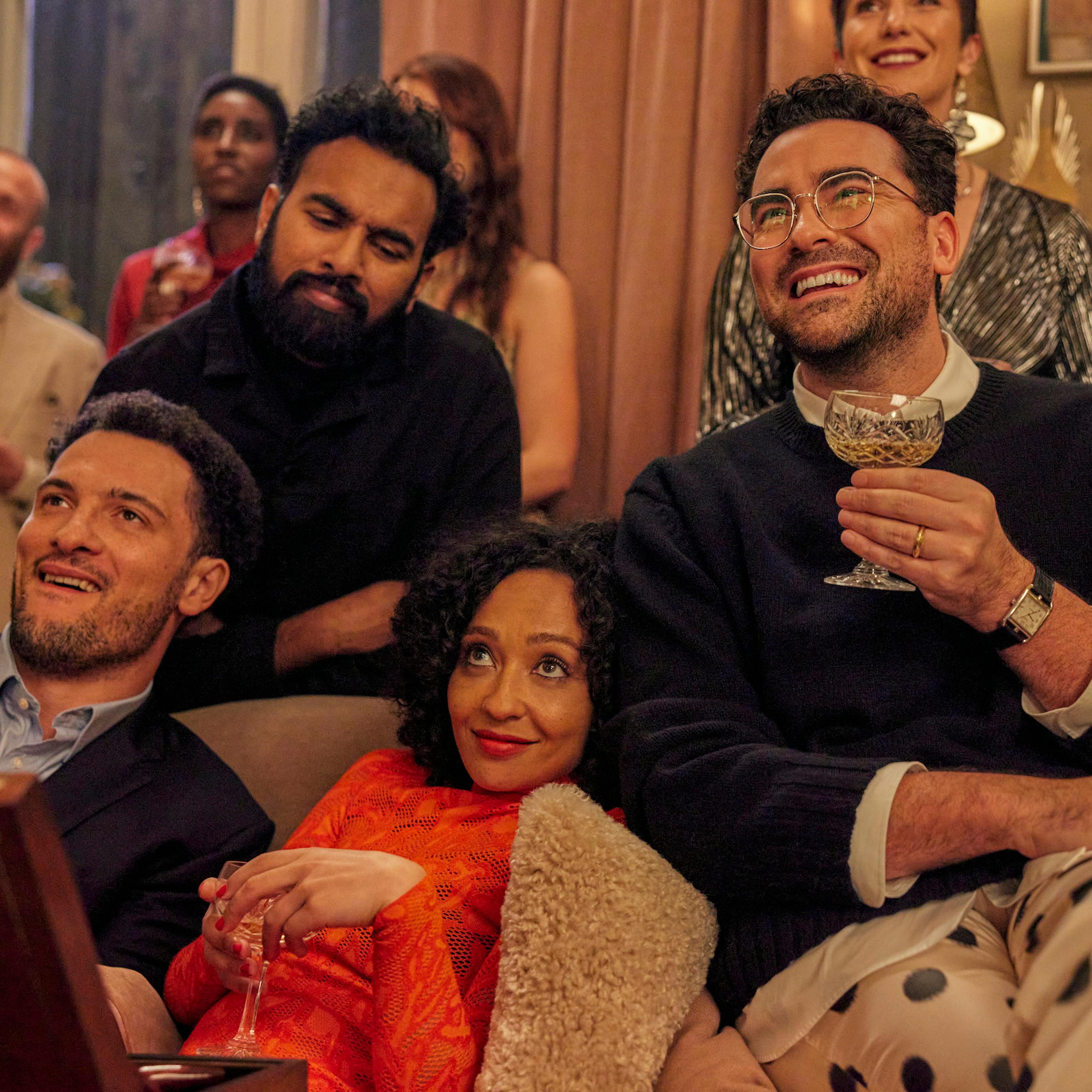 Terrance (Jamael Westman), Thomas (Himesh Patel), Sophie (Ruth Negga), and Marc (Daniel Levy) pile onto the couch at a Christmas party.