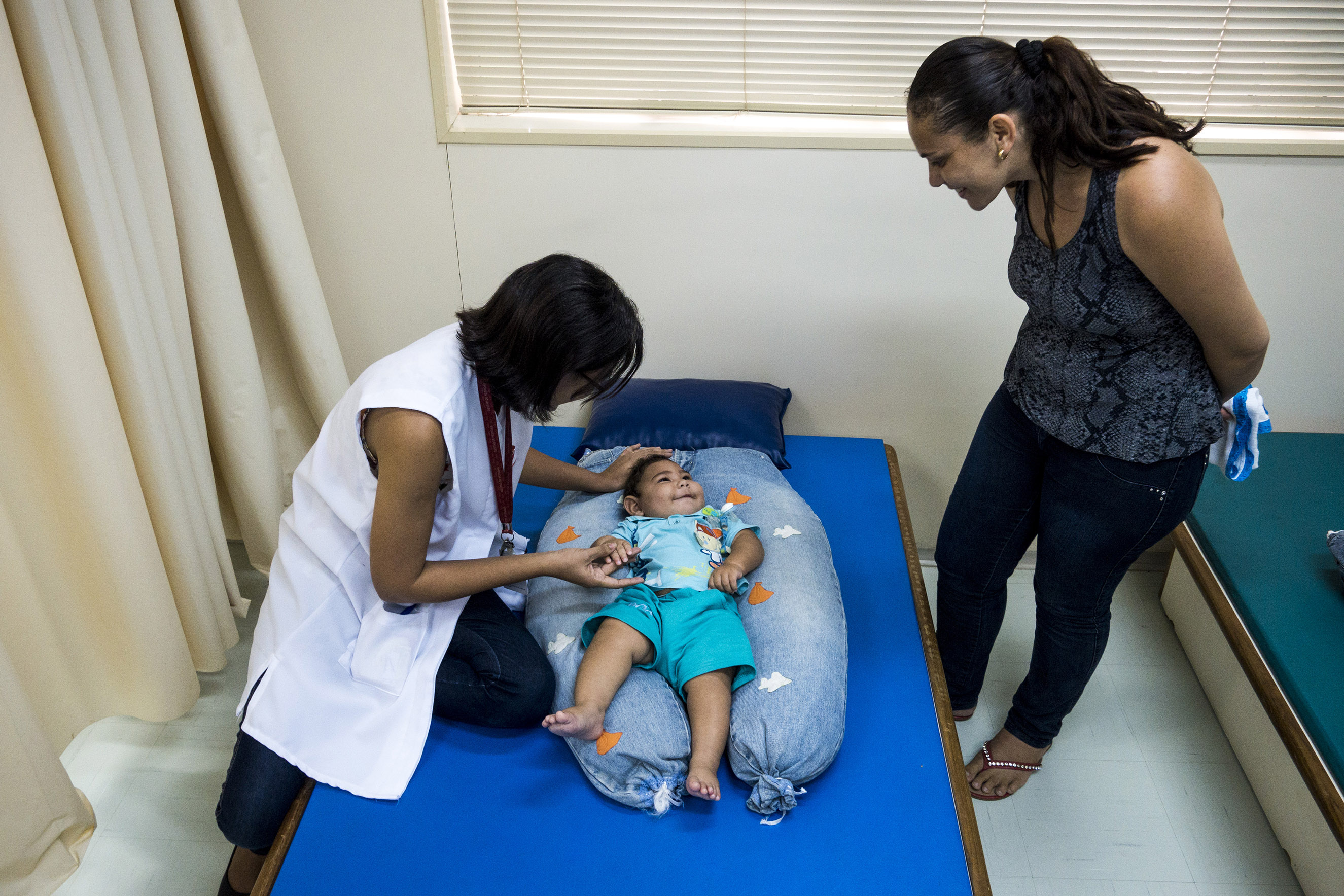 Dr. Cynthia de Melo Silva Ximenes, a physical therapist, works with Adriana Cordeiro da Silva, 29, and her 7-month-year-old son Jose Bernardo at the Associacao de Assistencia a Crianca Deficiente rehabilitation center in Recife, Brazil, Feb. 1, 2016. She