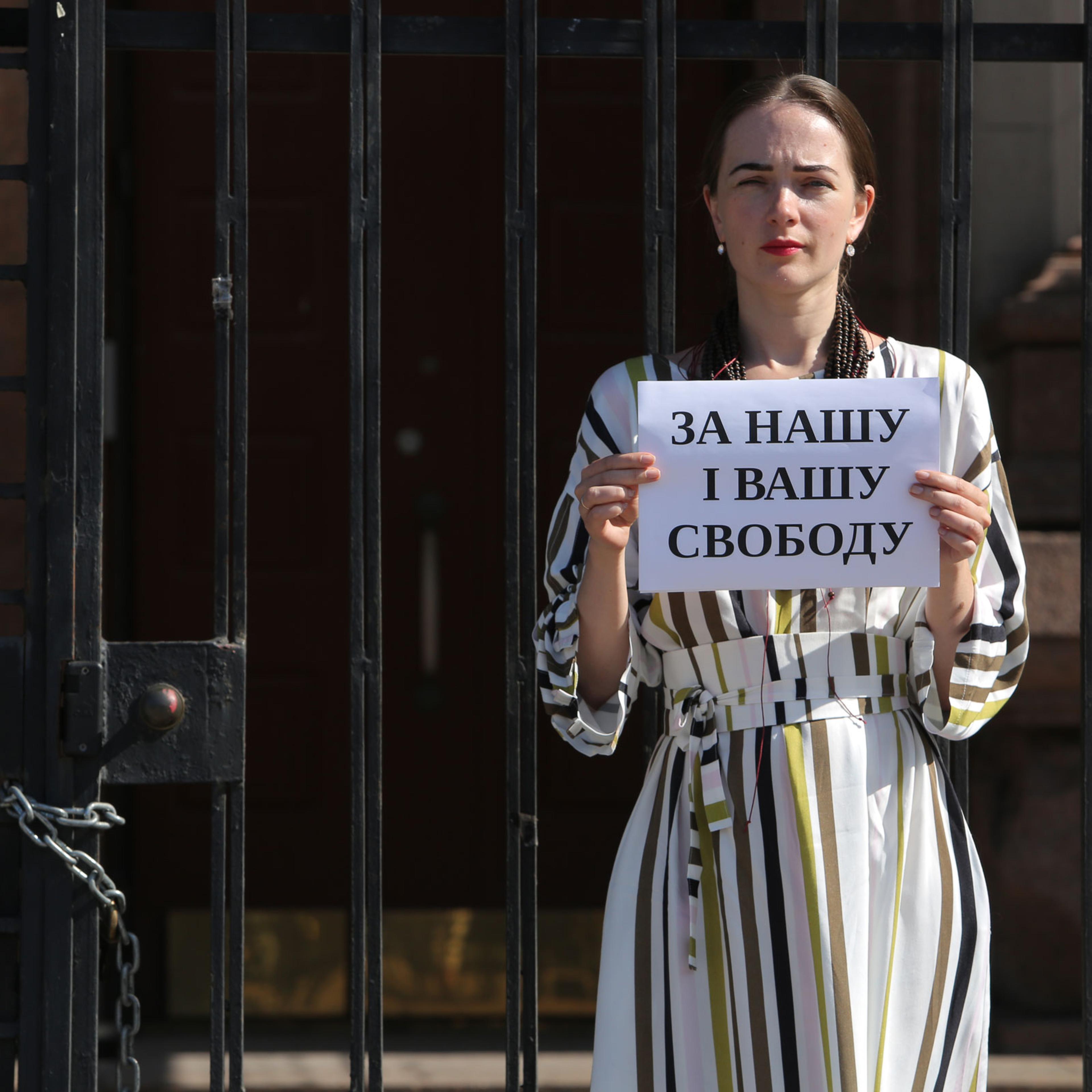 Ukrainian activist Oleksandra Matviichuk holds a placard which says “For Your and Our Freedom” as she protests in front of Russian Embassy against decision of Russian court to jail IT professional Konstantin Kotov, in Kyiv, Ukraine, on Sept. 5, 2019.