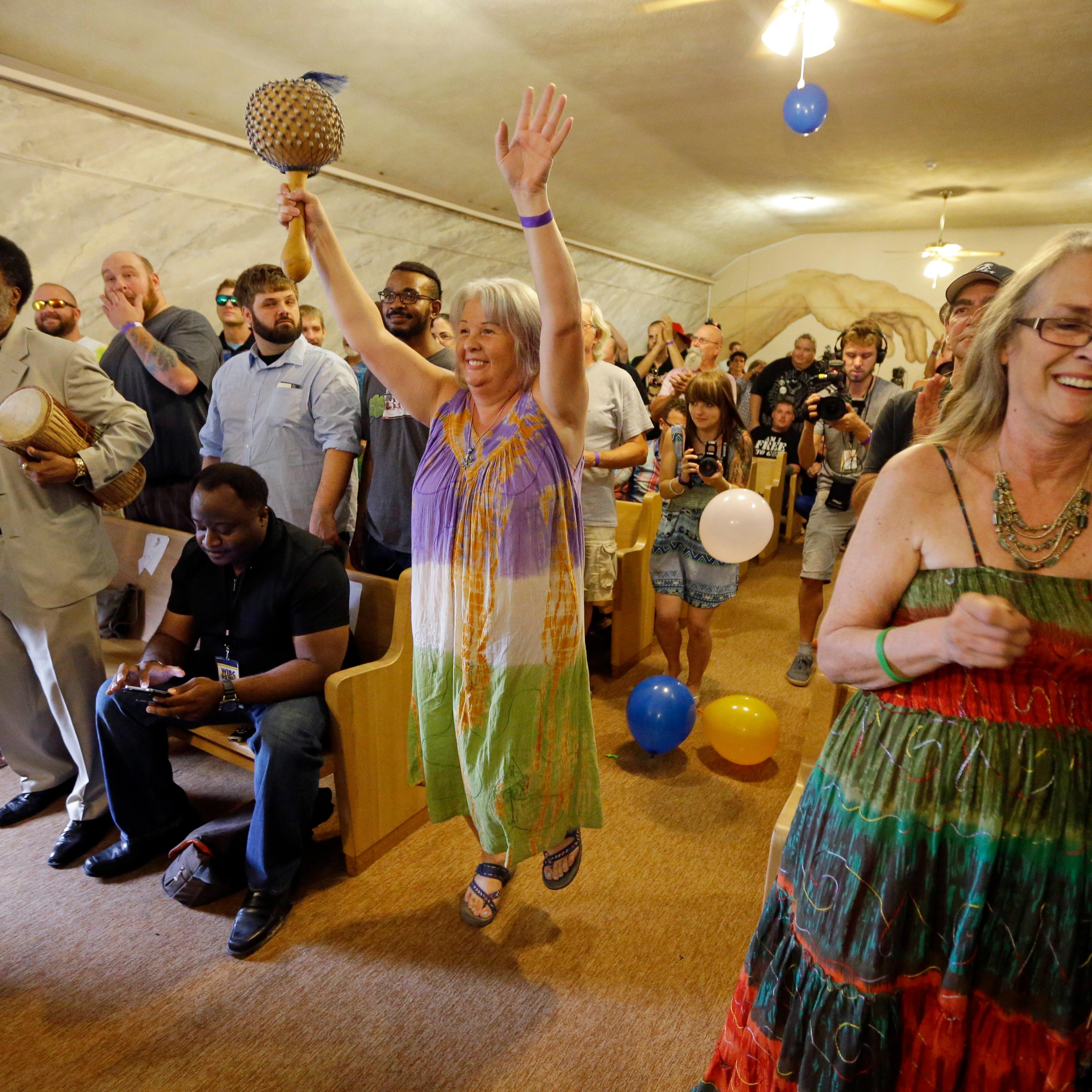 Members of the congregation at the First Church of Cannabis sing and dance during the church's first service on July 1, 2015, in Indianapolis.