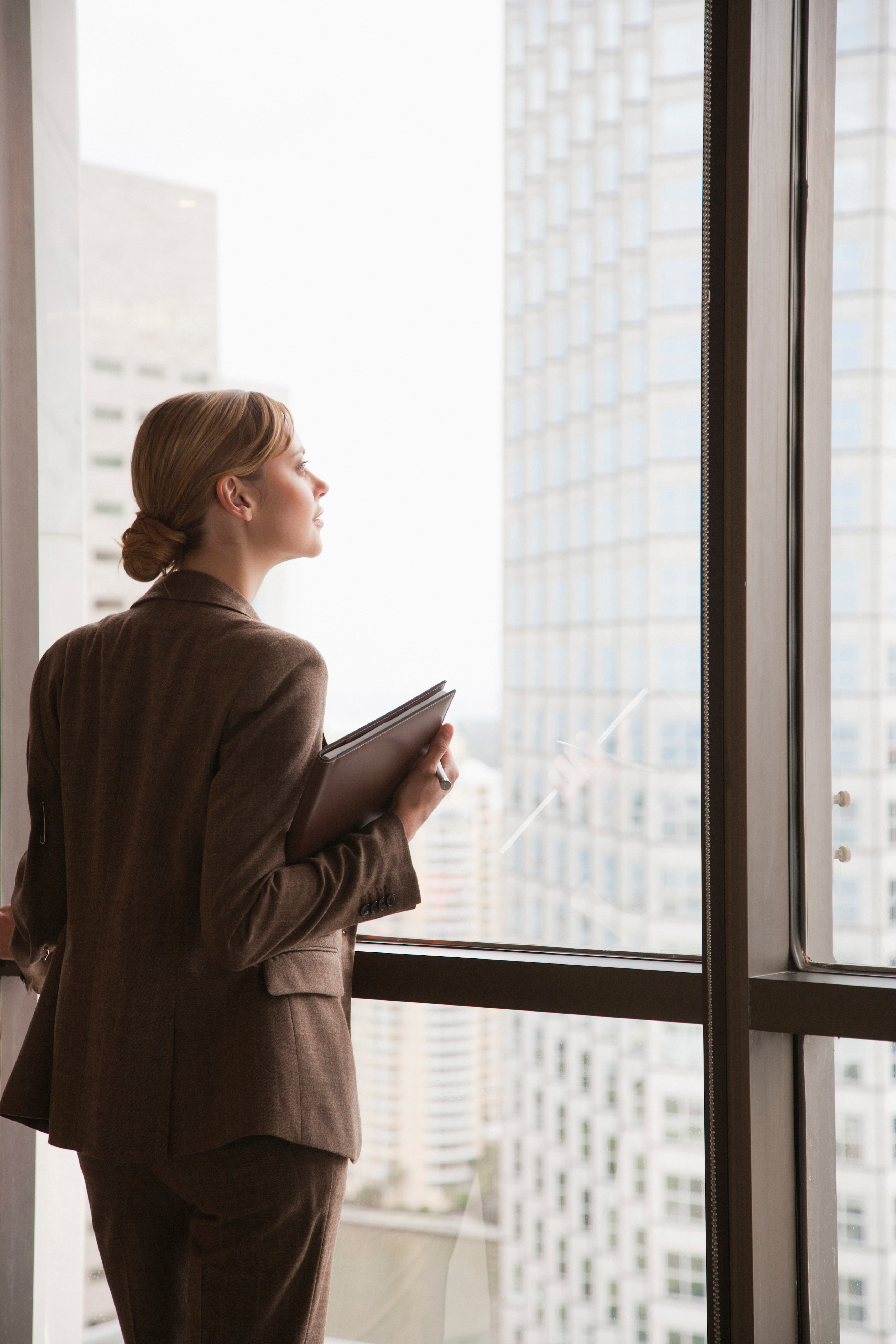businesswoman-looking-out-window
