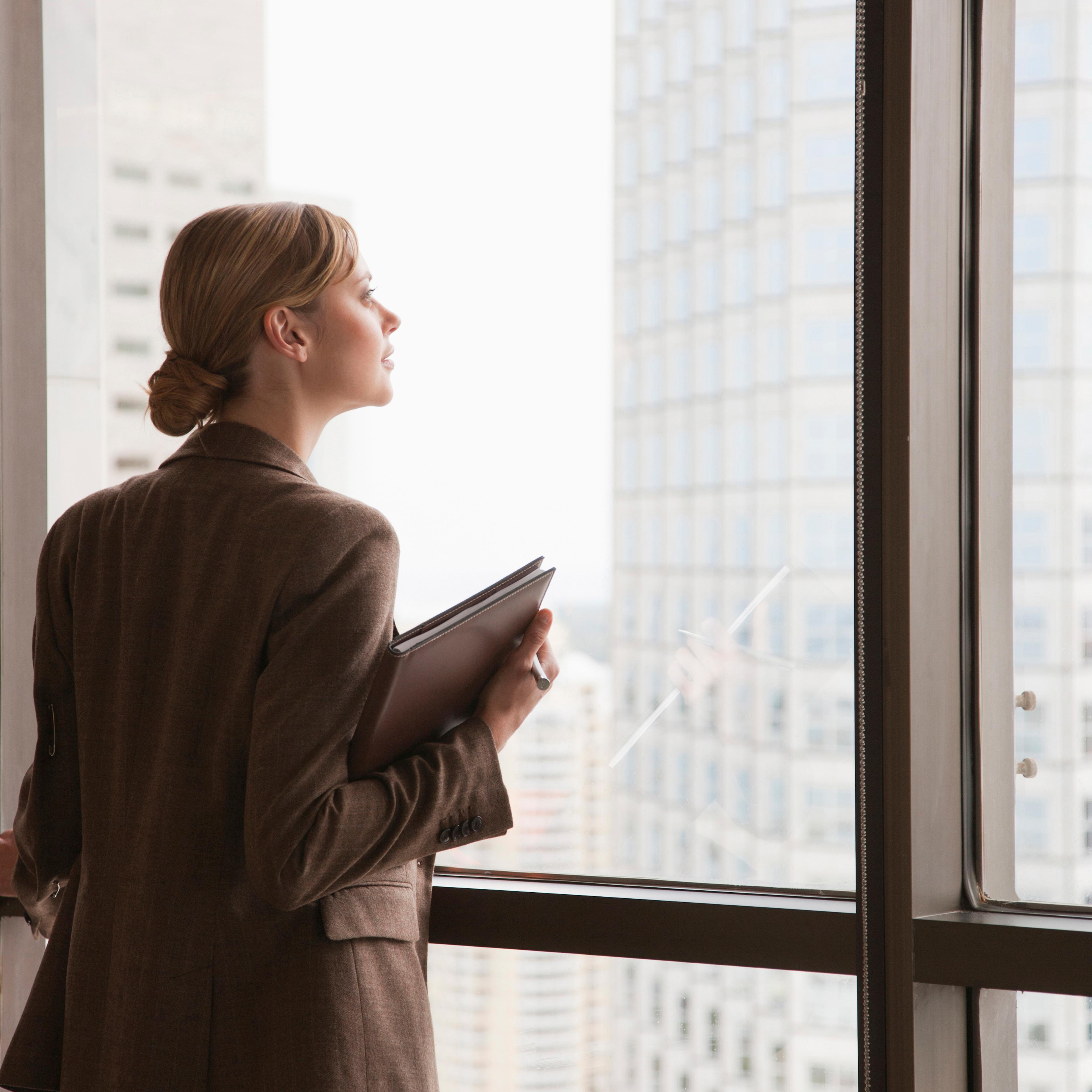 businesswoman-looking-out-window