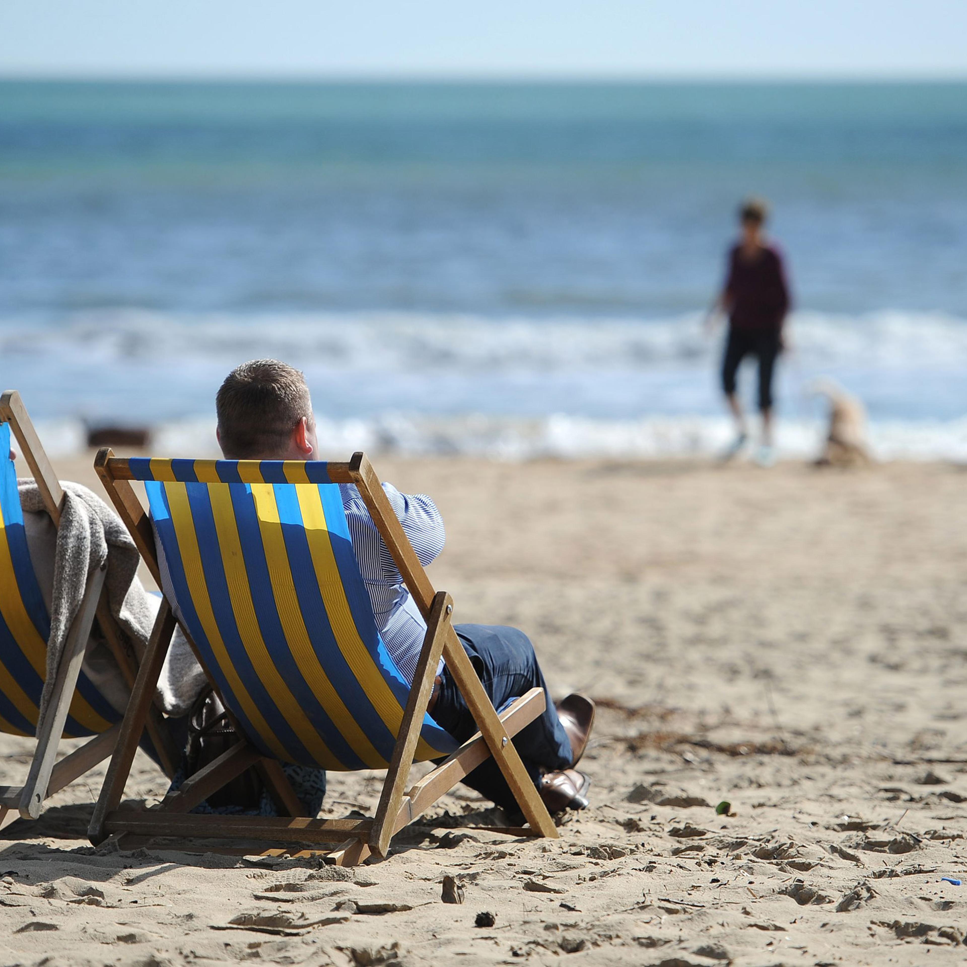 Spring weather Mar 25th 2016. People enjoying the sun sitting in deckchairs on Bournemouth beach. Picture date: Friday March 25, 2016. See PA story WEATHER Easter. Photo credit should read: Andrew Matthews/PA Wire URN:25916481