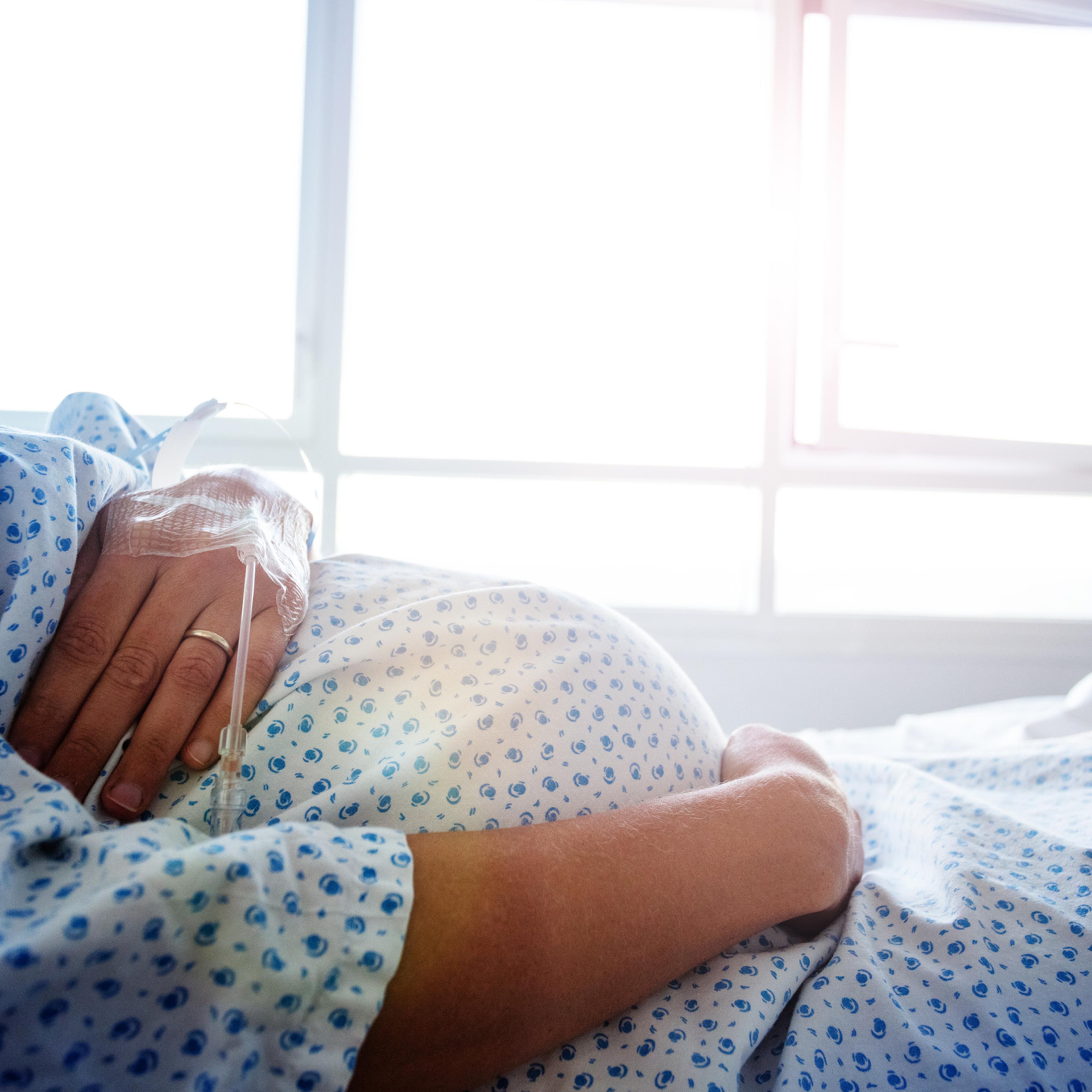 Close-up of a pregnant woman's belly in hospital