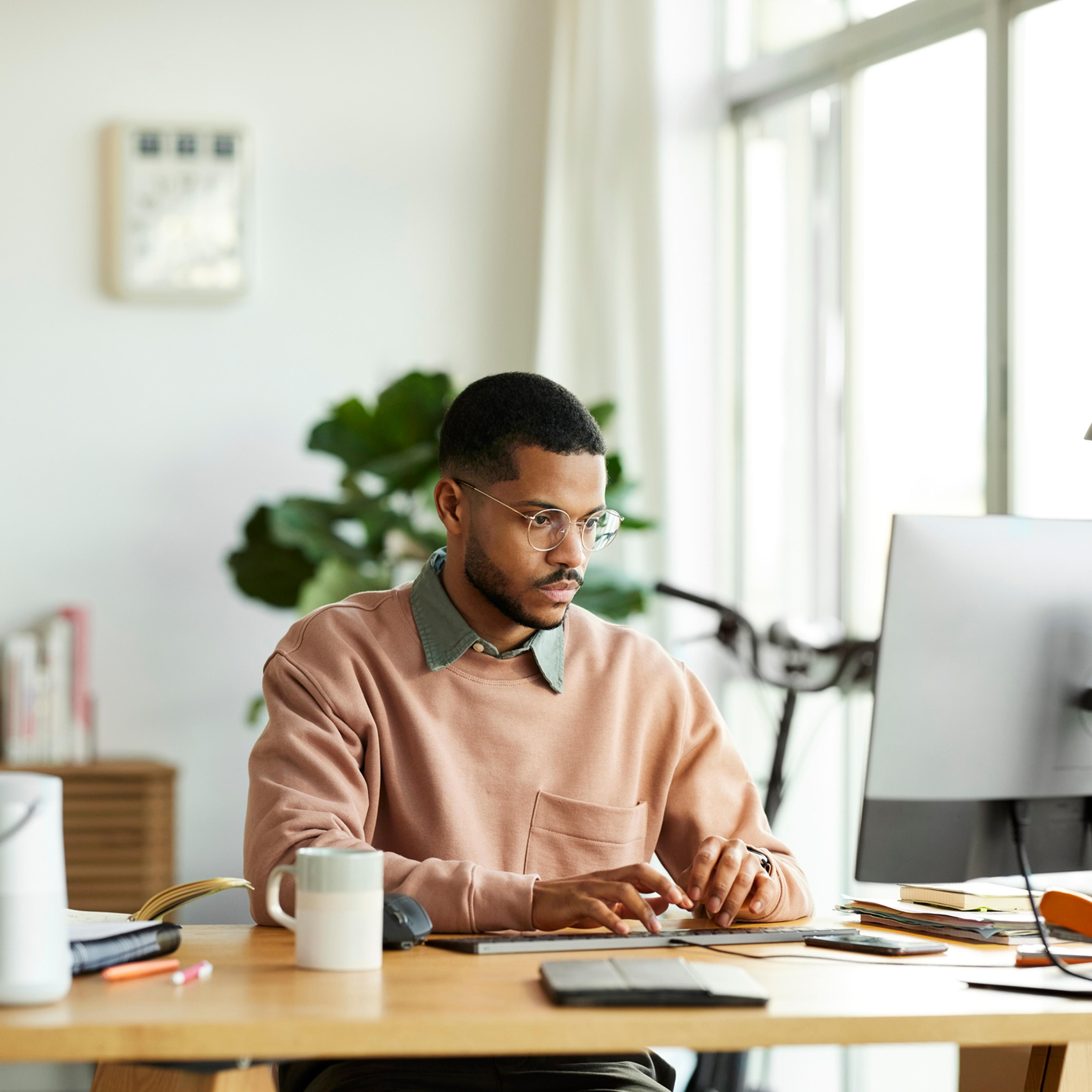 Freelancer Using Computer At Home Office