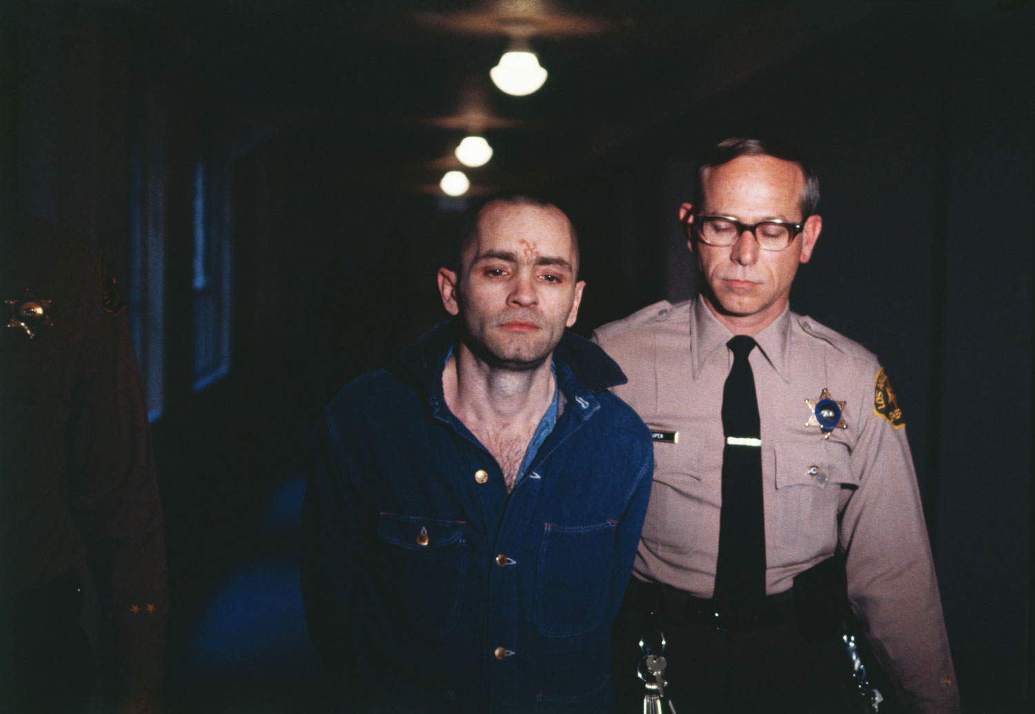 Convicted murderer Manson is led back to the courtroom to hear the penalty he and this three female followers must pay for the Tate-LaBianca murders, on March 29, 1971.