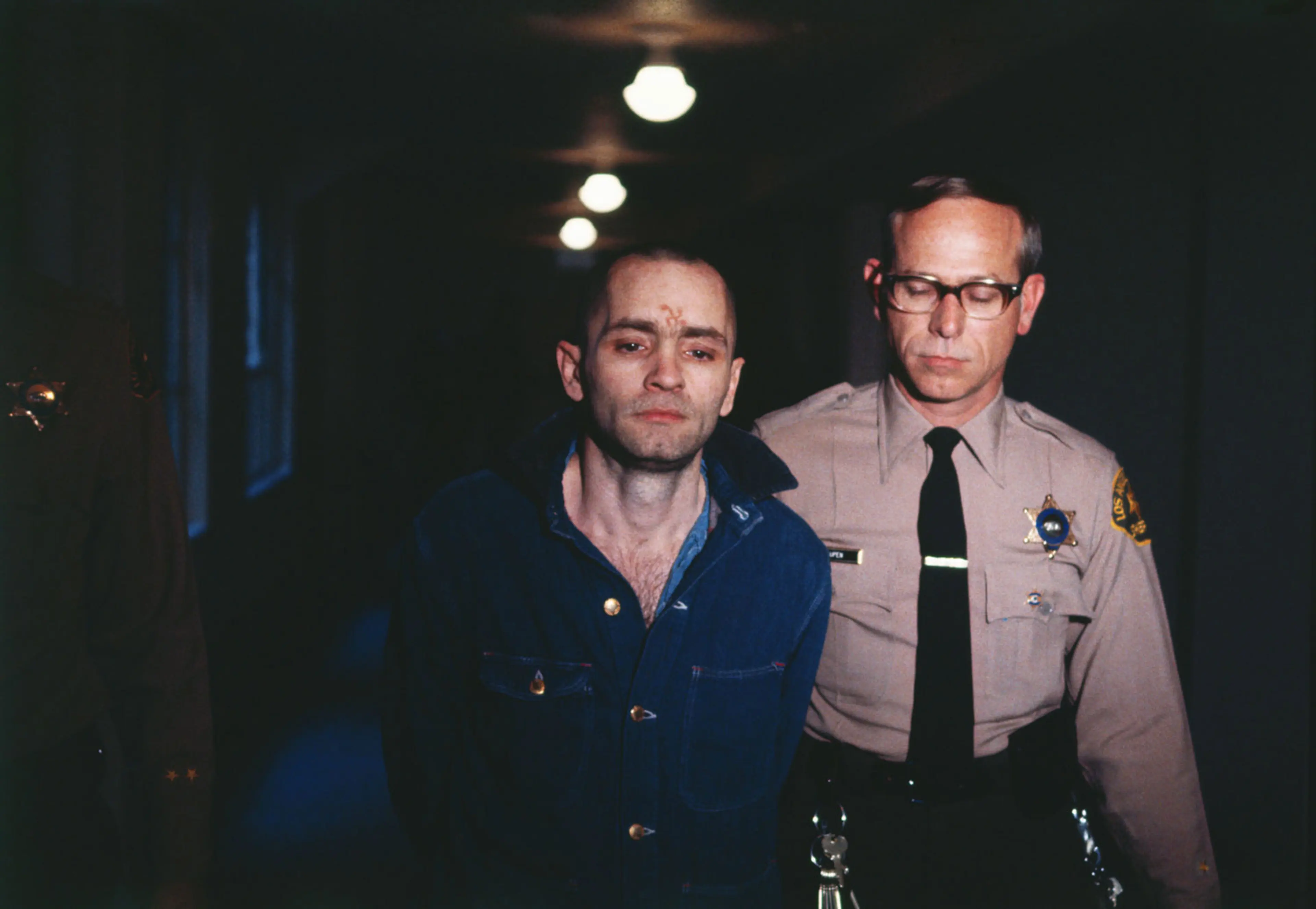 Convicted murderer Manson is led back to the courtroom to hear the penalty he and this three female followers must pay for the Tate-LaBianca murders, on March 29, 1971.