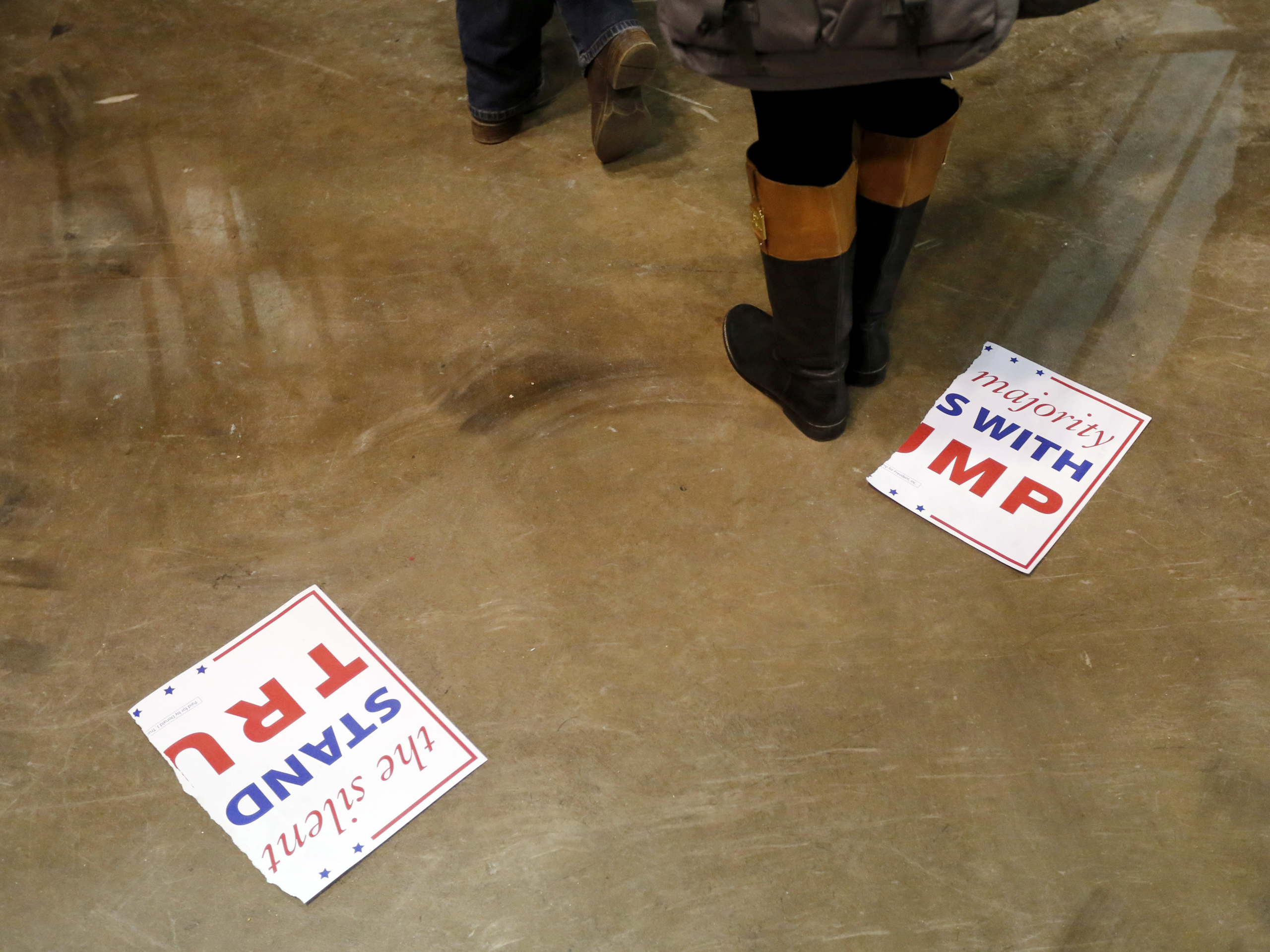 A torn campaign sign for Republican presidential candidate Donald Trump, lays on the floor after a rally for Trump was canceled due to security concerns, on the campus of the University of Illinois-Chicago, Friday, March 11, 2016, in Chicago. (AP Photo/C
