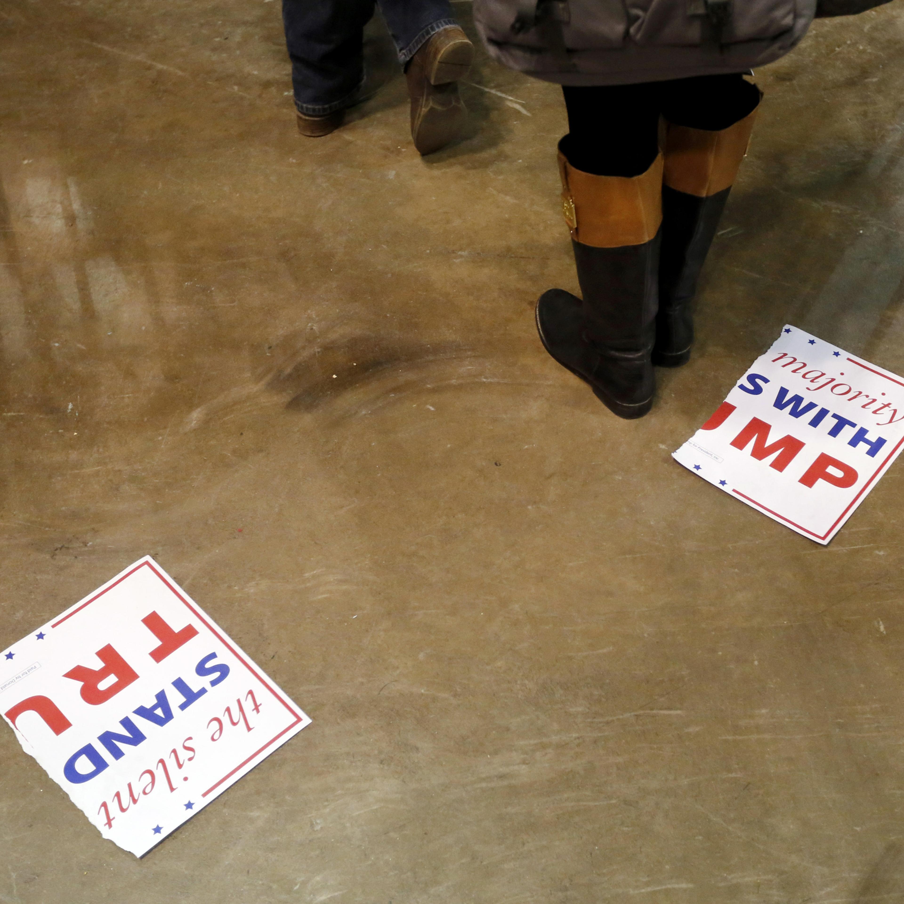 A torn campaign sign for Republican presidential candidate Donald Trump, lays on the floor after a rally for Trump was canceled due to security concerns, on the campus of the University of Illinois-Chicago, Friday, March 11, 2016, in Chicago. (AP Photo/C