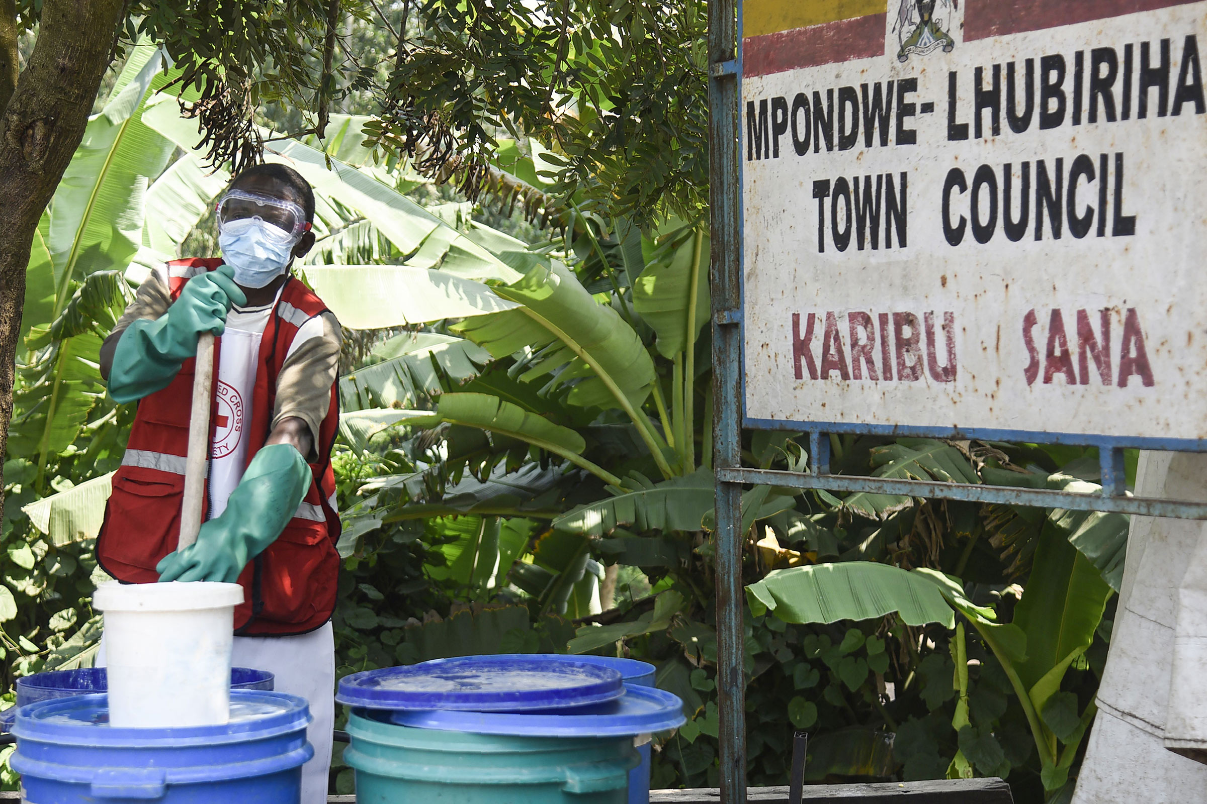 A health worker makes a chlorine solution for sanitisation at the Mpondwe Health Screening Facility in Mpondwe, the Uganda's border town with the Democratic Republic of Congo, on June 13.