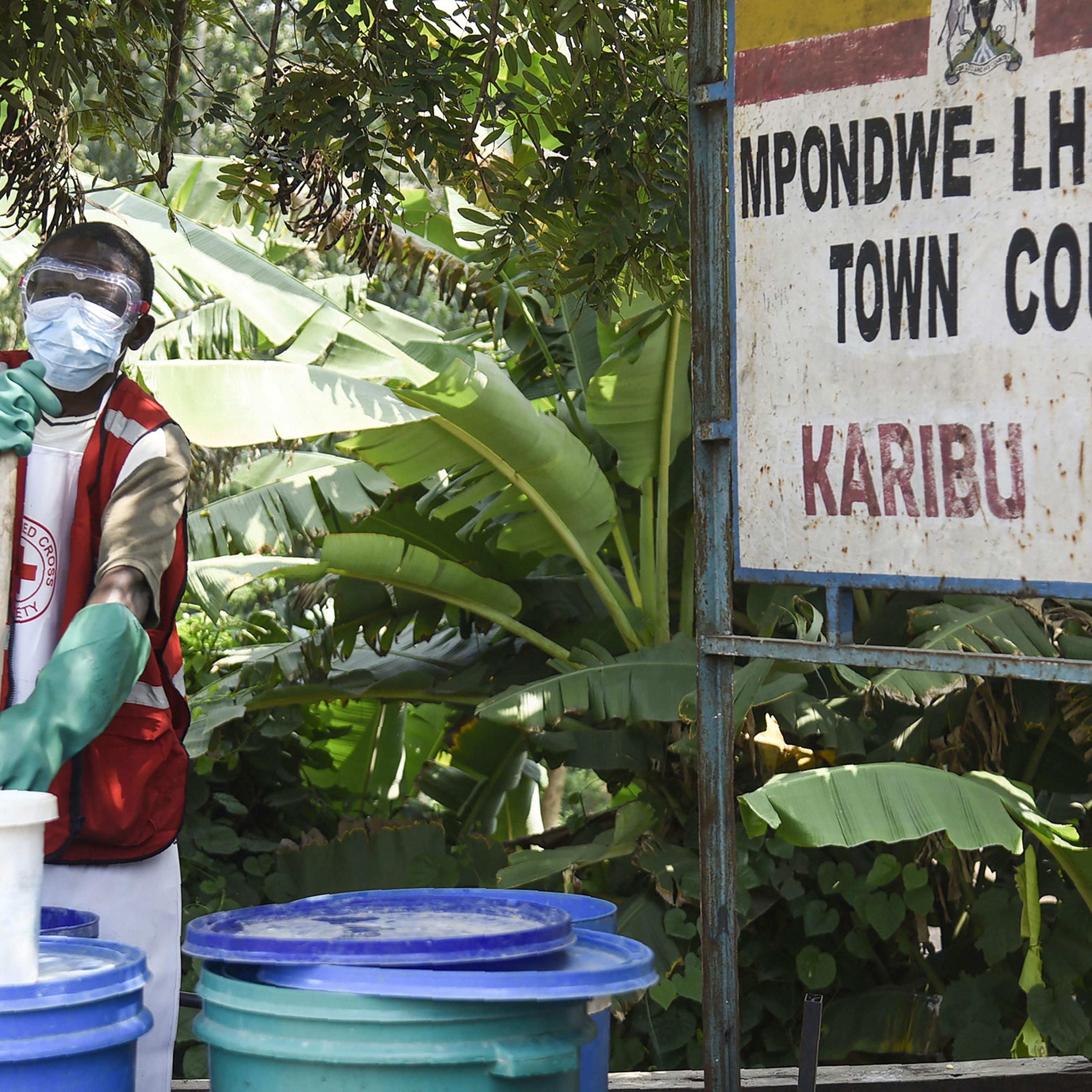 A health worker makes a chlorine solution for sanitisation at the Mpondwe Health Screening Facility in Mpondwe, the Uganda's border town with the Democratic Republic of Congo, on June 13.
