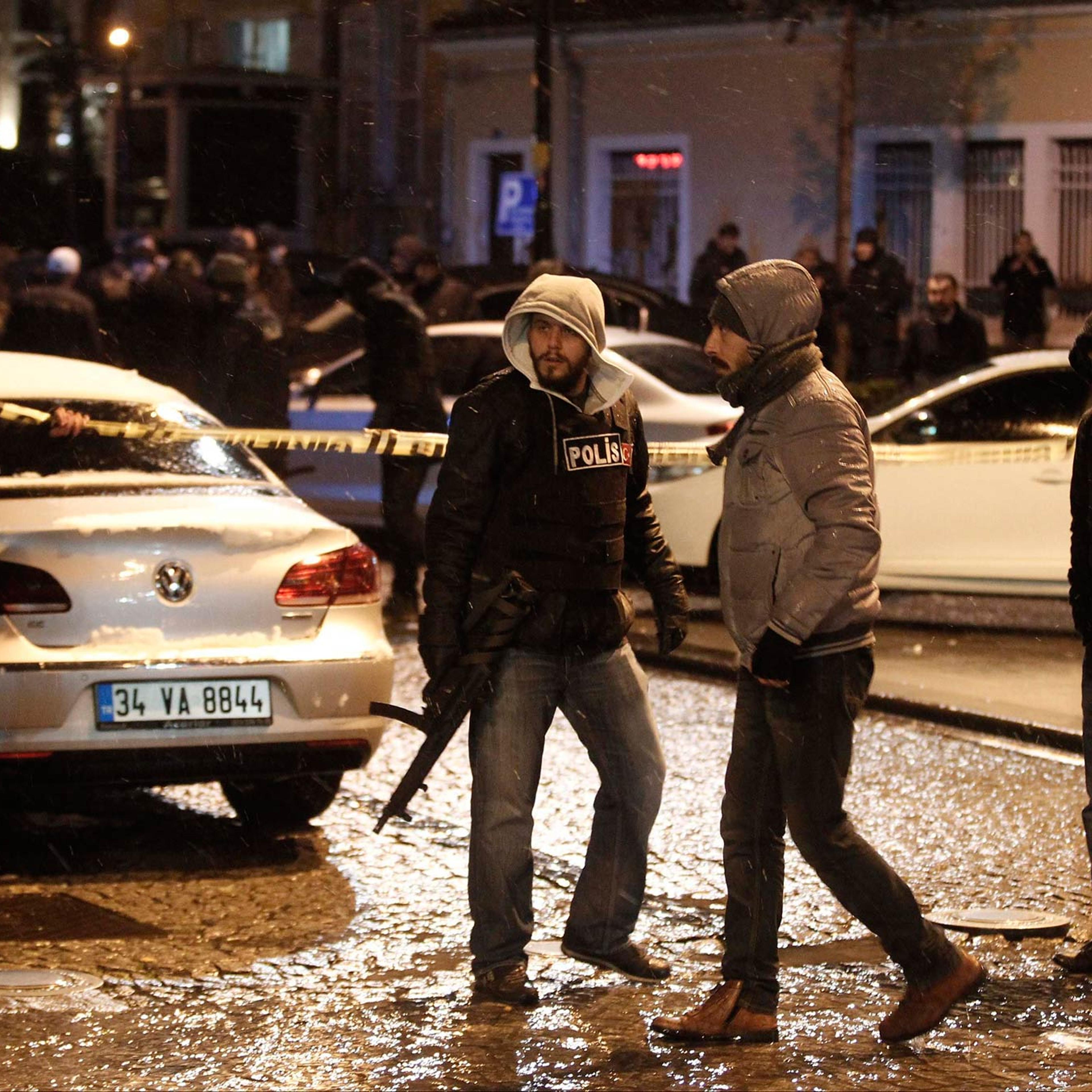 Police officers stand guard at the scene of a bomb blast in Istanbul