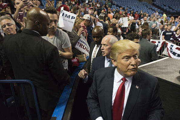 Donald Trump, president and chief executive of Trump Organization Inc. and 2016 Republican presidential candidate, right, is seen after greeting attendees during a campaign rally in Buffalo, New York, U.S., on Monday, April 18, 2016.