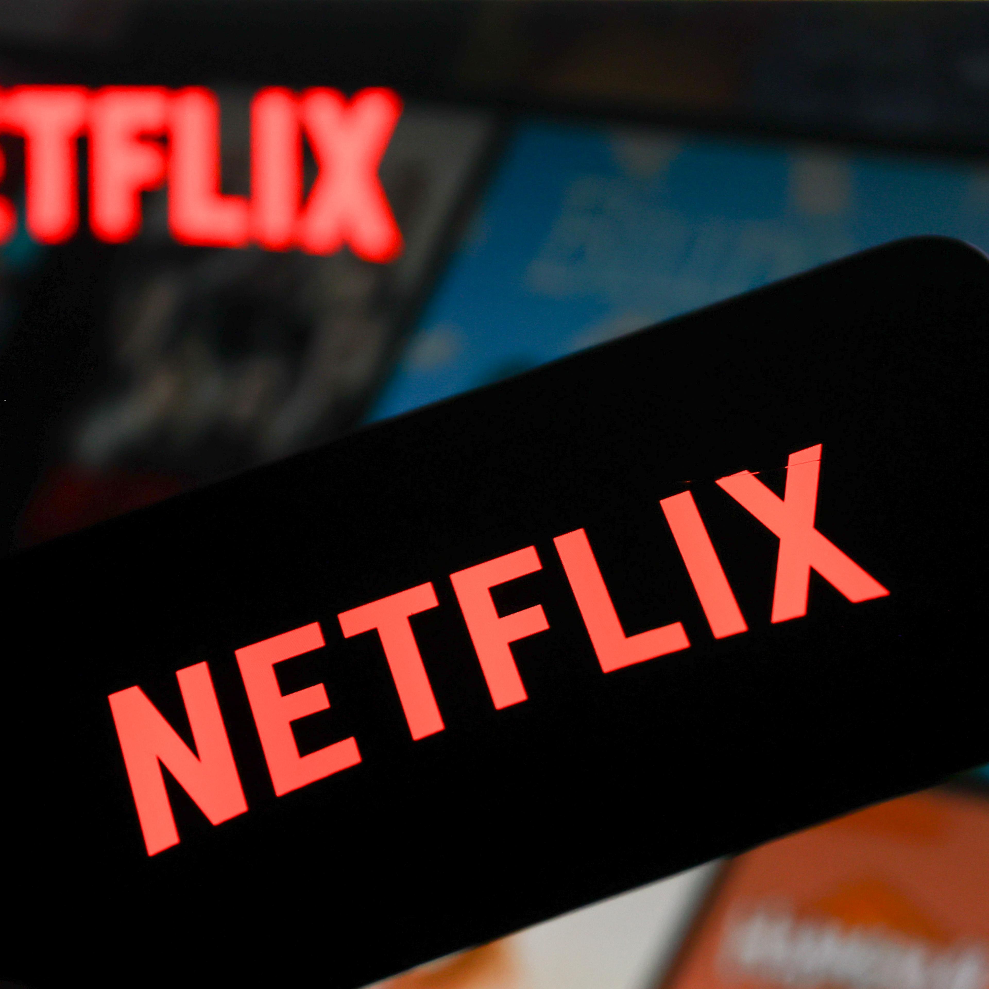 Netflix logo displayed on a phone screen and Netflix website displayed on a laptop screen are seen in this photo illustration.