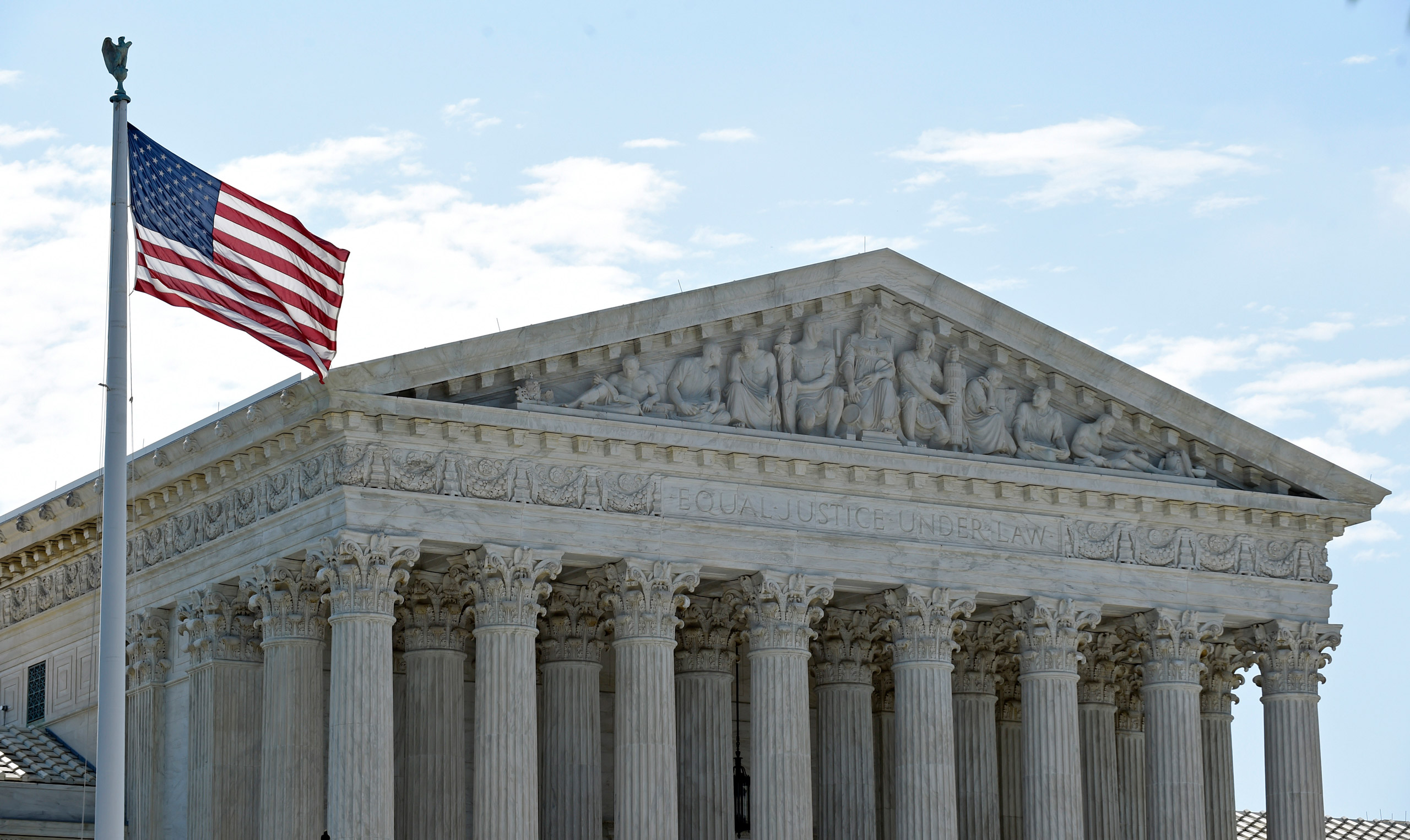 The American flag flies in the wind in front of the Supreme Court in Washington, Monday, June 22, 2015. Several key opinions are still to be released at the court nears the end of its term at the end of the month. (AP Photo/Susan Walsh)