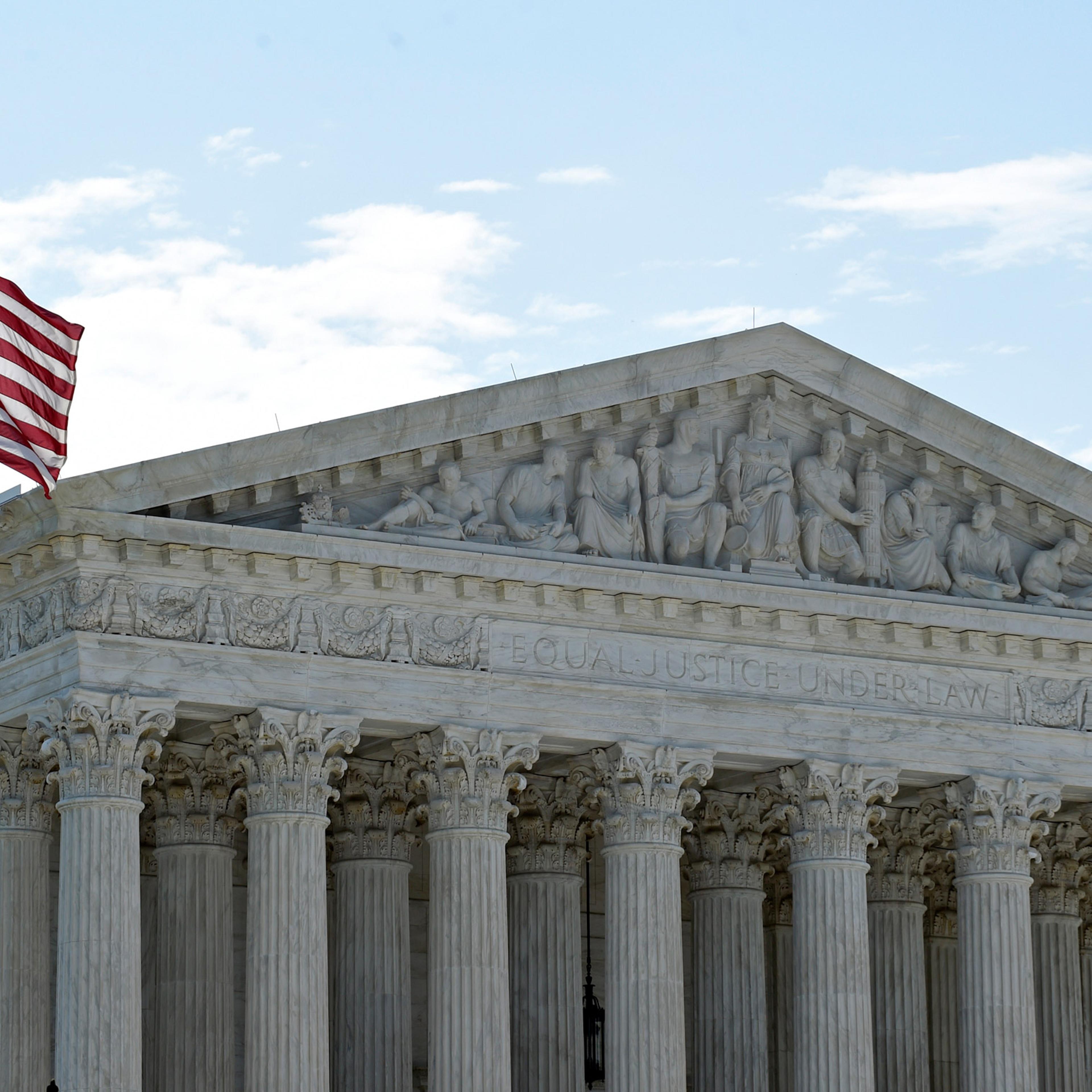 The American flag flies in the wind in front of the Supreme Court in Washington, Monday, June 22, 2015. Several key opinions are still to be released at the court nears the end of its term at the end of the month. (AP Photo/Susan Walsh)